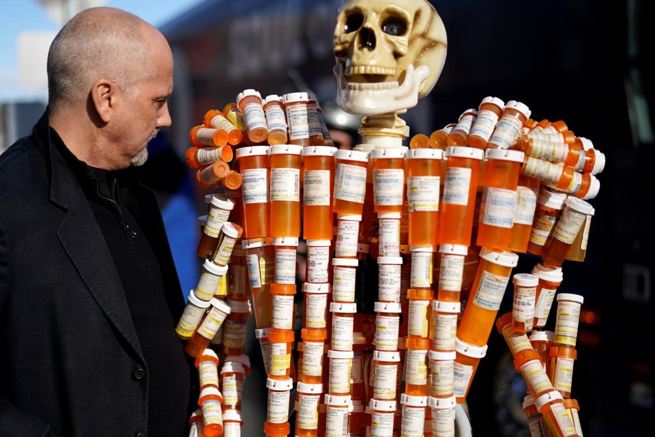 Frank Huntley looks at his sculpture made out of the opioid pill bottles he got when addicted, in Somersworth, New Hampshire on February 5, 2020.
