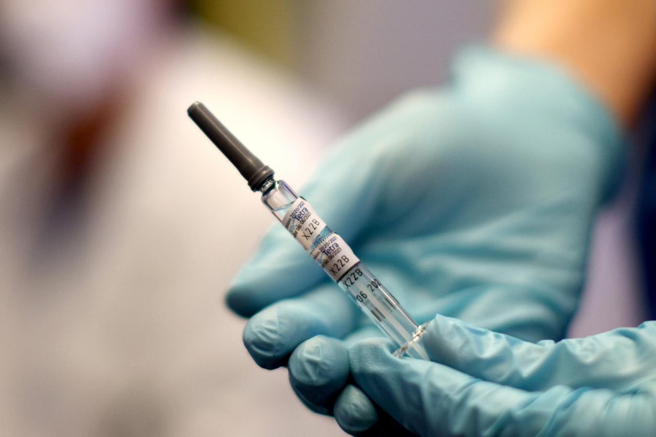 A healthcare worker of the free influenza vaccination program holds a flu vaccine.