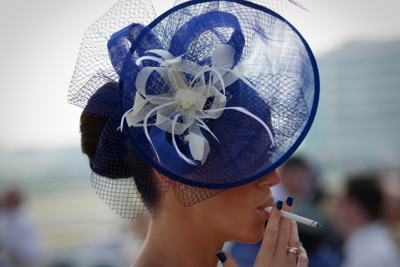 a spectator smokes a cigarette