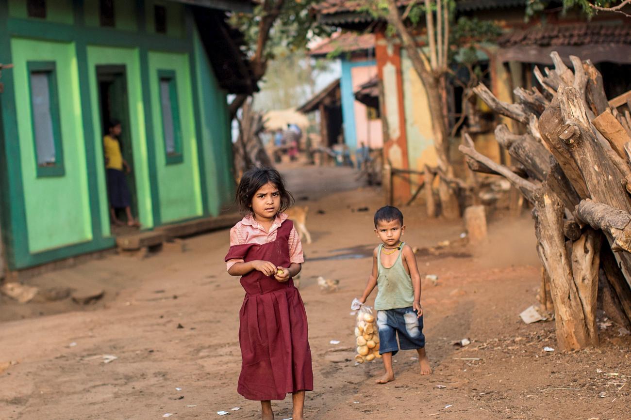 Children walk near a general store.