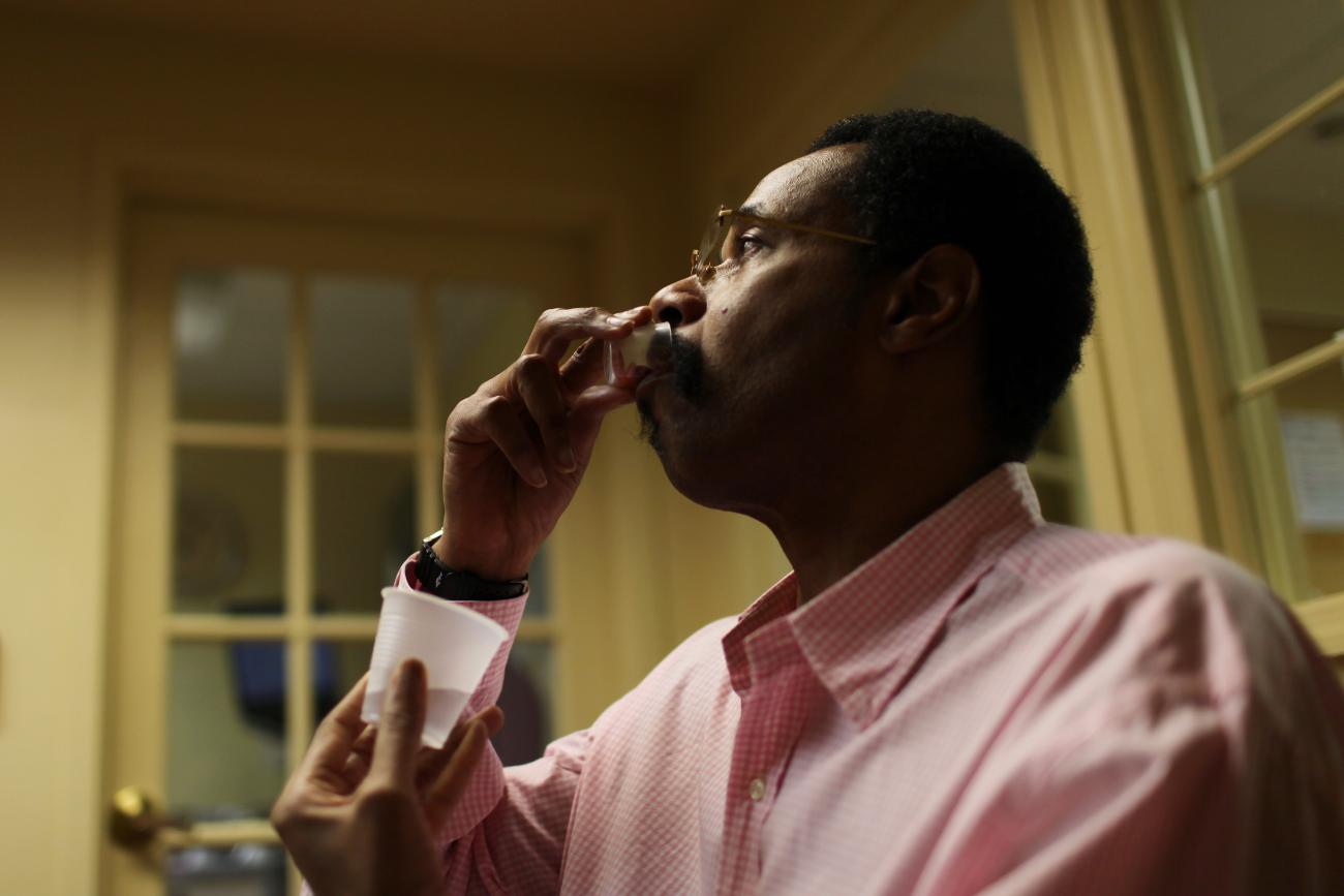 Michael Campbell, 58, receives his daily dose of medication for AIDS at Broadway House for Continuing care