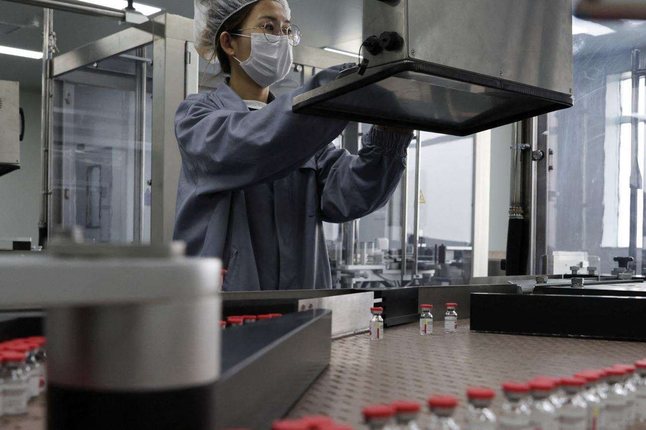 An employee works on the production line of CanSino Biologics Inc's single-dose vaccine against COVID-19.