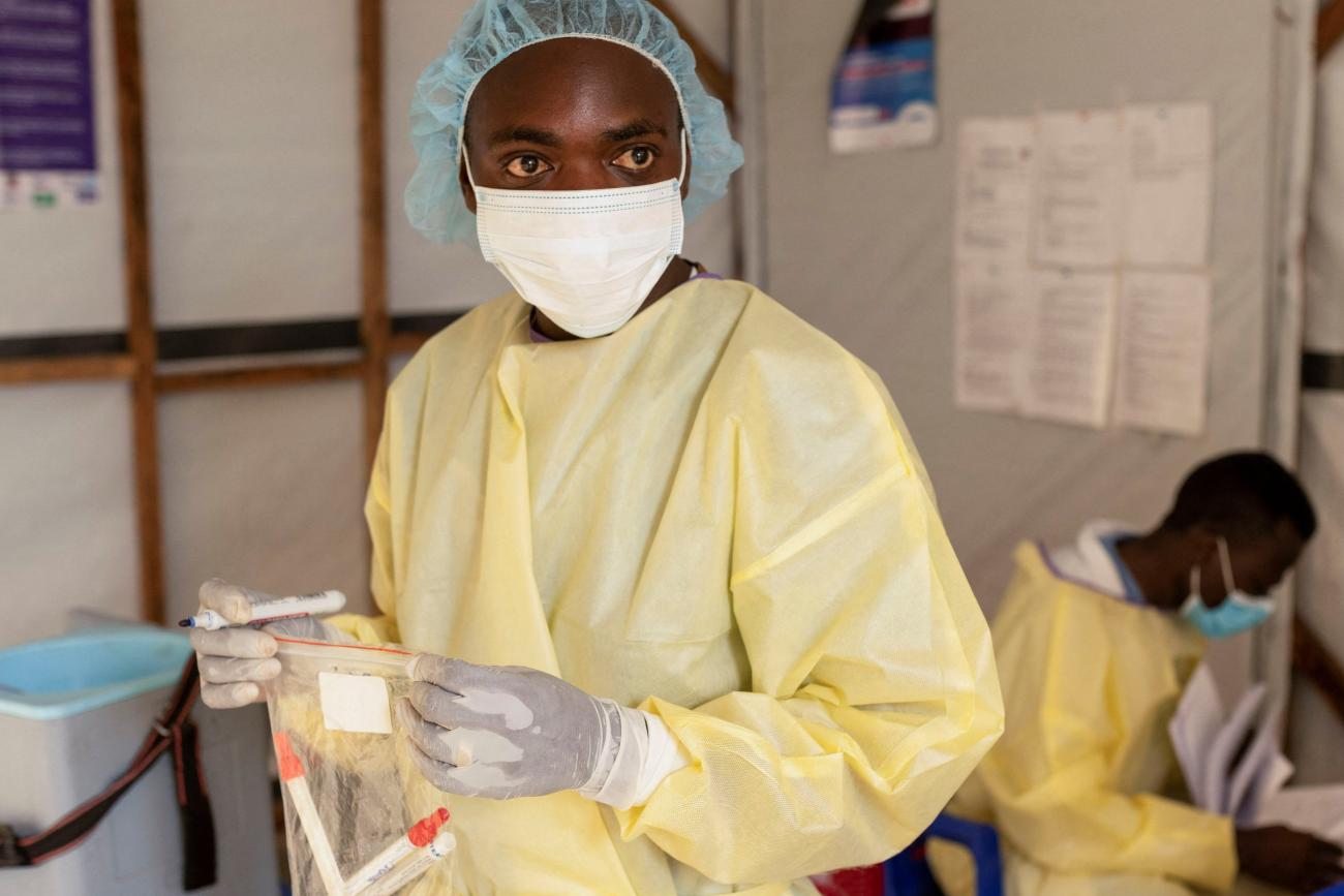 A laboratory nurse carries samples taken from a child with a suspected case of mpox.