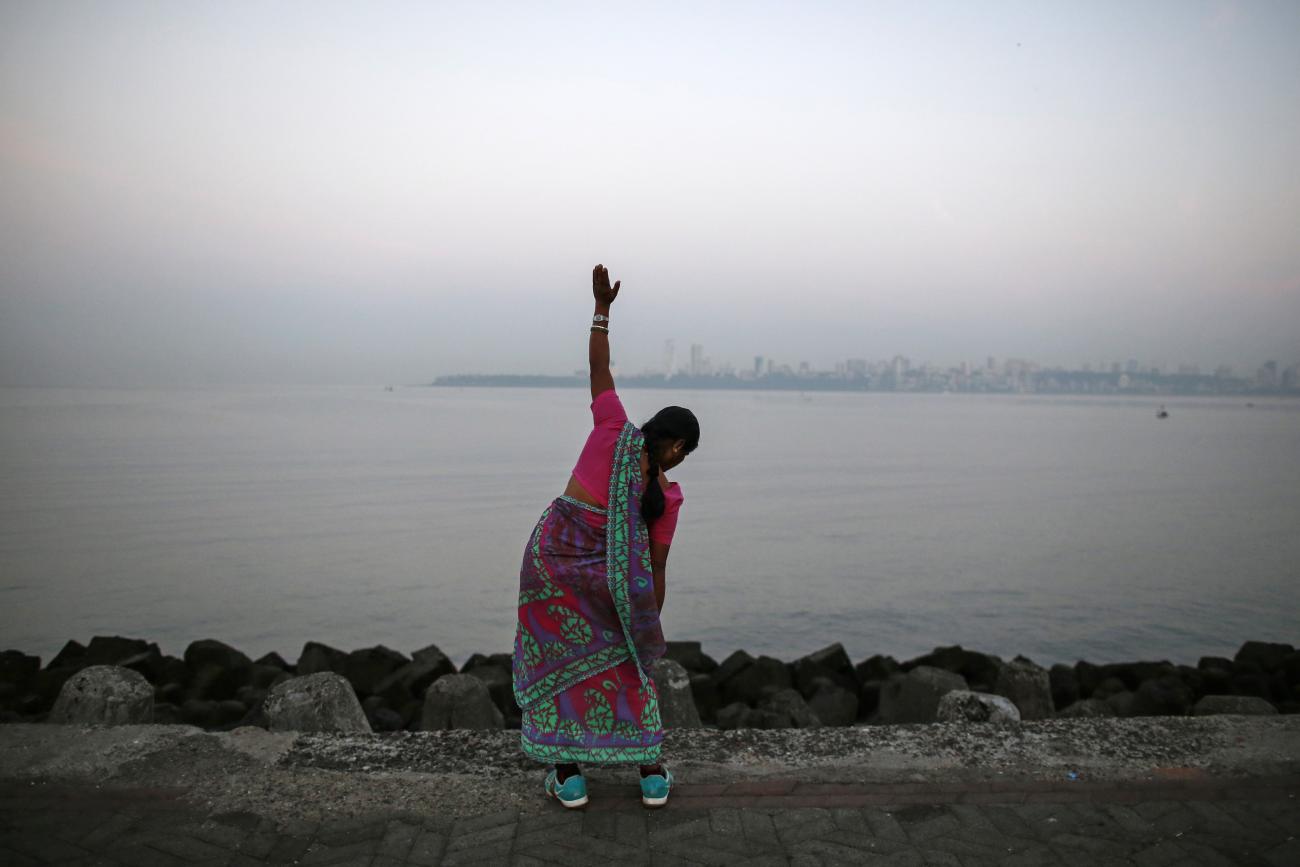 A woman exercises along the Arabian Sea.