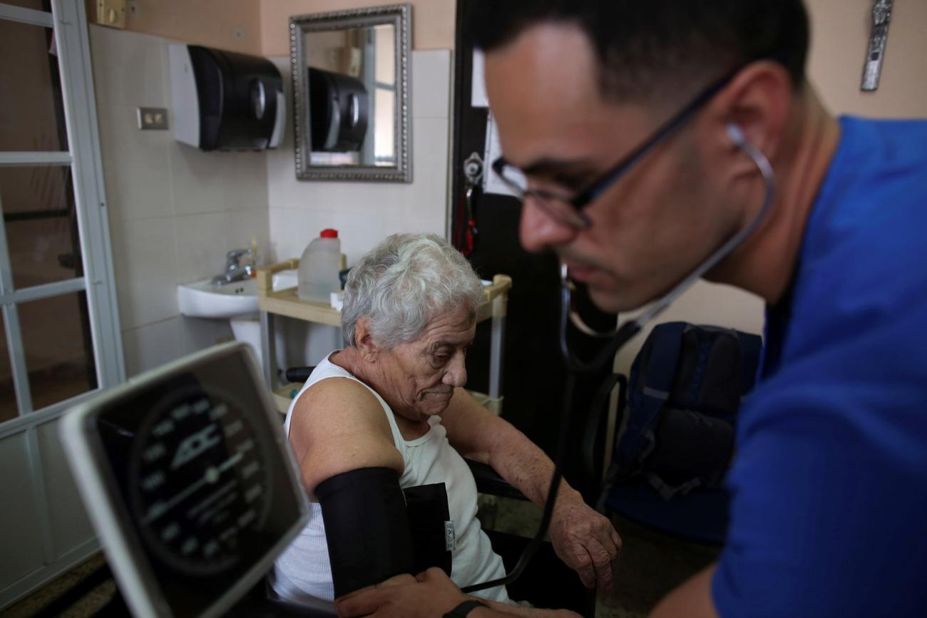 A nurse checks the blood pressure of a patient at the San Rafael nursing home.