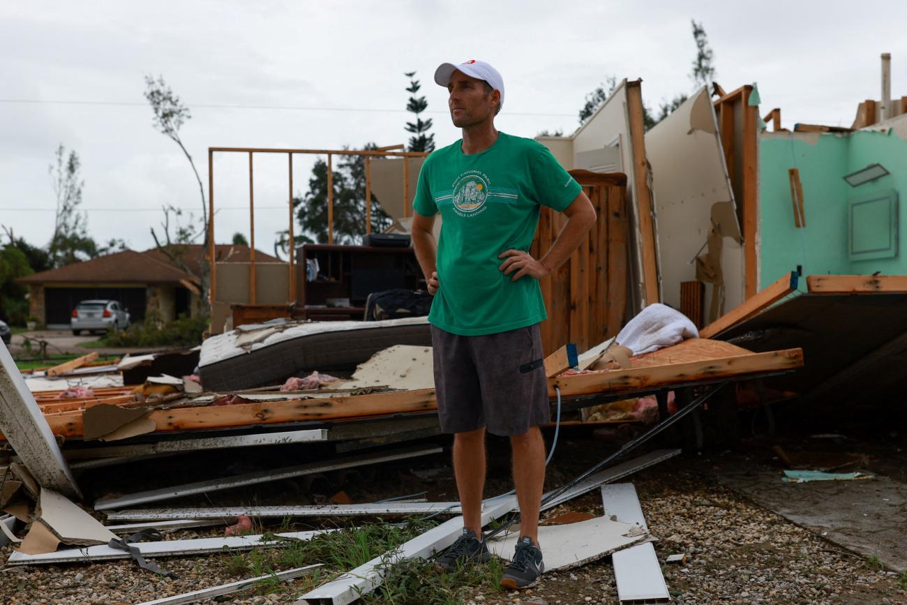 Shane Ostrander stands in front of his damaged house after Hurricane Milton made landfall.