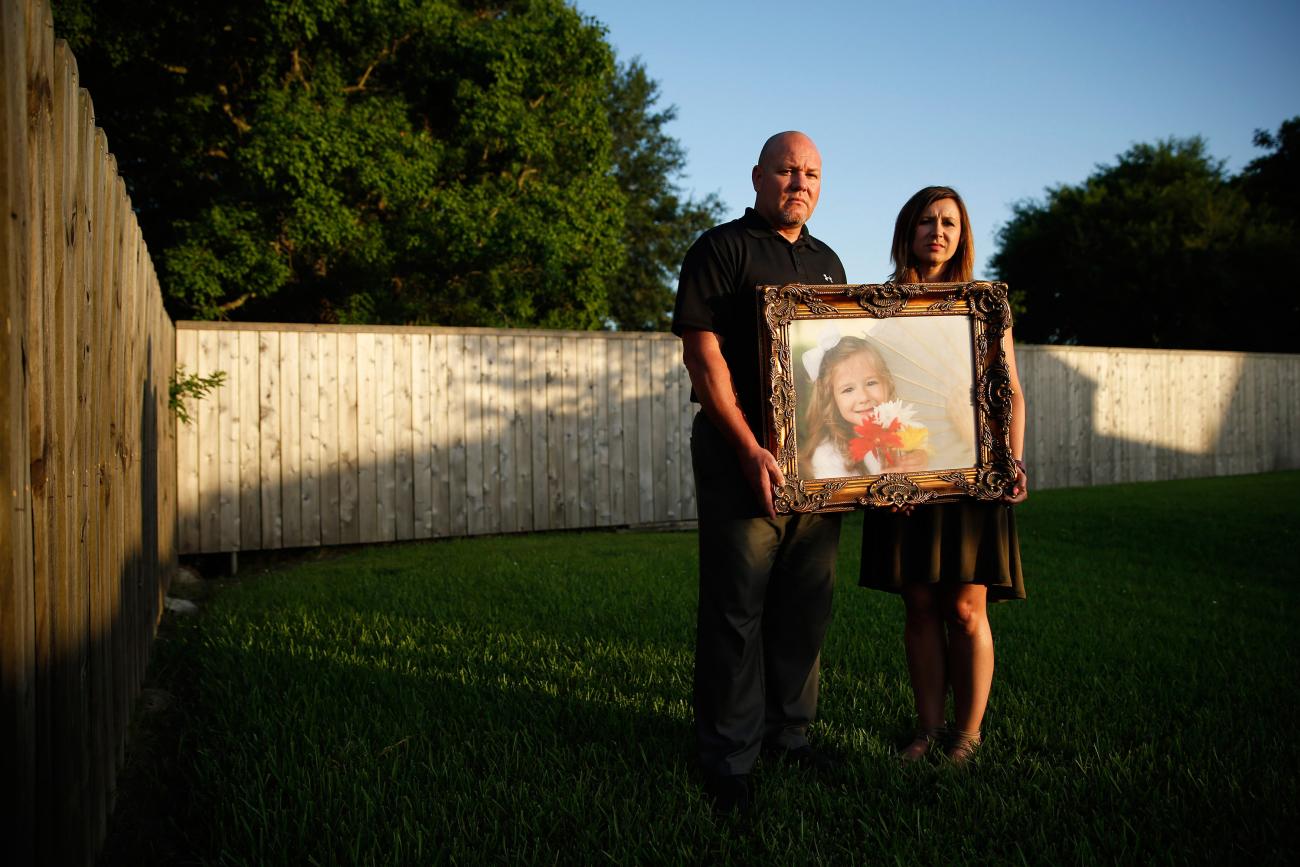 Kelly and Ryan Breaux stand holding a portrait of their deceased daughter Emma Breaux, at their home in Breaux Bridge, Louisiana, on June 16, 2016. The husband and wife lost twins, Emma and Talon, to different superbugs that they contracted while in the neonatal unit at Lafayette General Hospital.