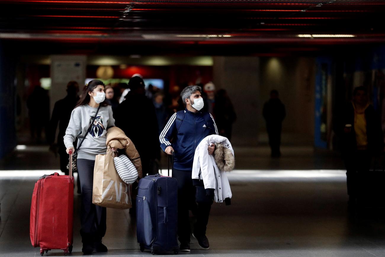 eople wearing masks are seen at a railway station, as the Czech government bans most travel to contain the spread of the COVID-19.