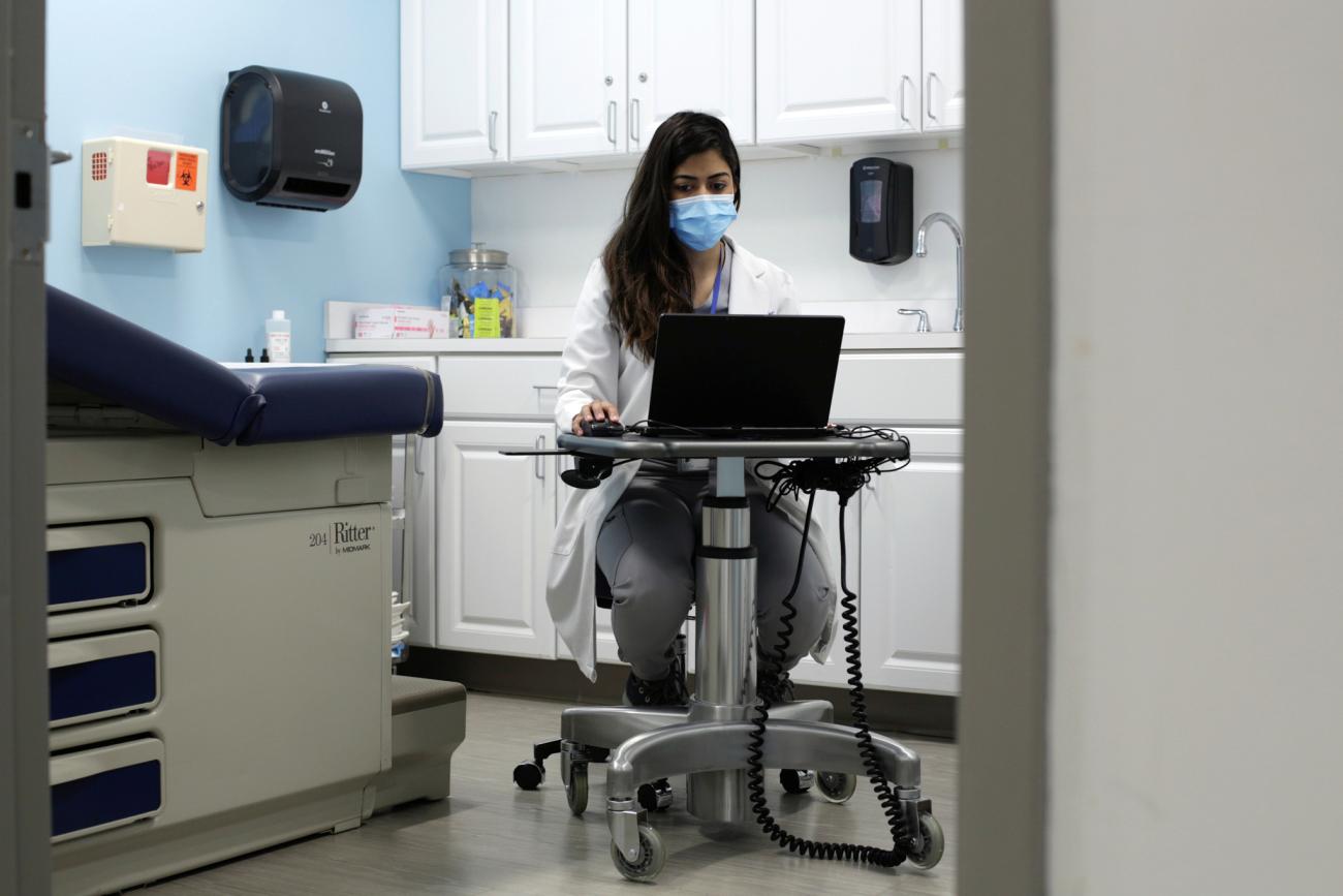 Dr. Meera Shah, the chief medical officer for Planned Parenthood Hudson Peconic, communicates with patients online in an unoccupied exam room in White Plains, New York, U.S., April 3, 2020.