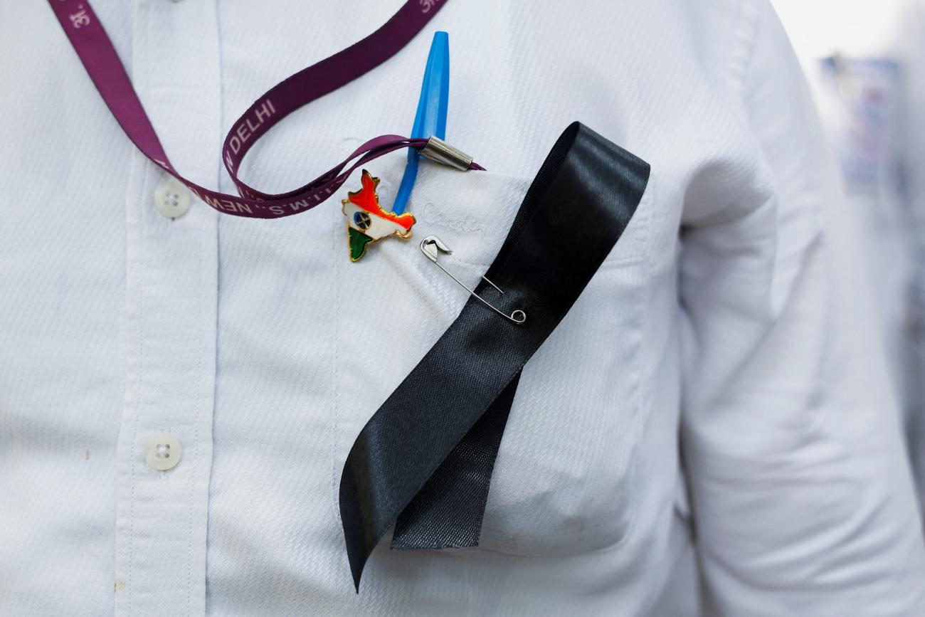 A doctor wears a ribbon and an India map badge on his shirt, during a protest rally demanding justice following the rape and murder of a trainee medic at a hospital in Kolkata, in New Delhi, India, August 16, 2024.