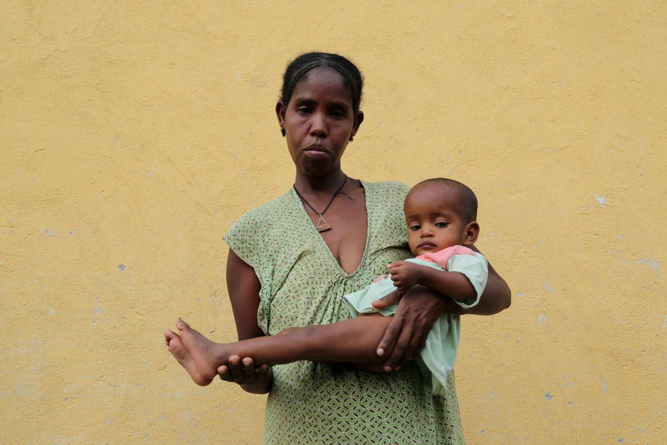 Tsegy Kiday, a 34-year-old displaced single mother of five, holds her 14-month-old daughter Mebrihit Hintsa, in Nebelet, Tigray region, Ethiopia, on July 11, 2021. 