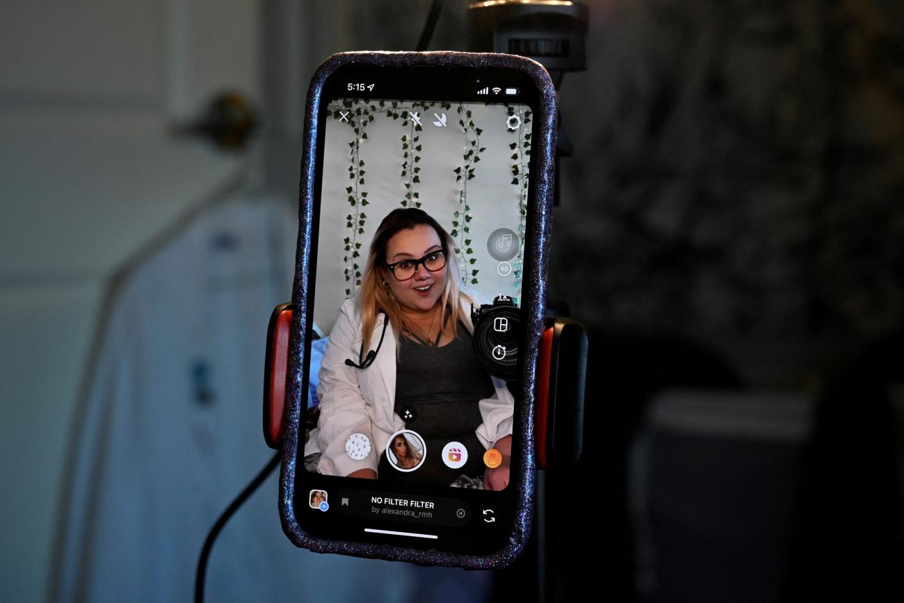 Nicole Spencer, who has postural orthostatic tachycardia syndrome, makes a video for her Instagram account, where she speaks about her medical condition, in Syracuse, New York, on May 8, 2022. 