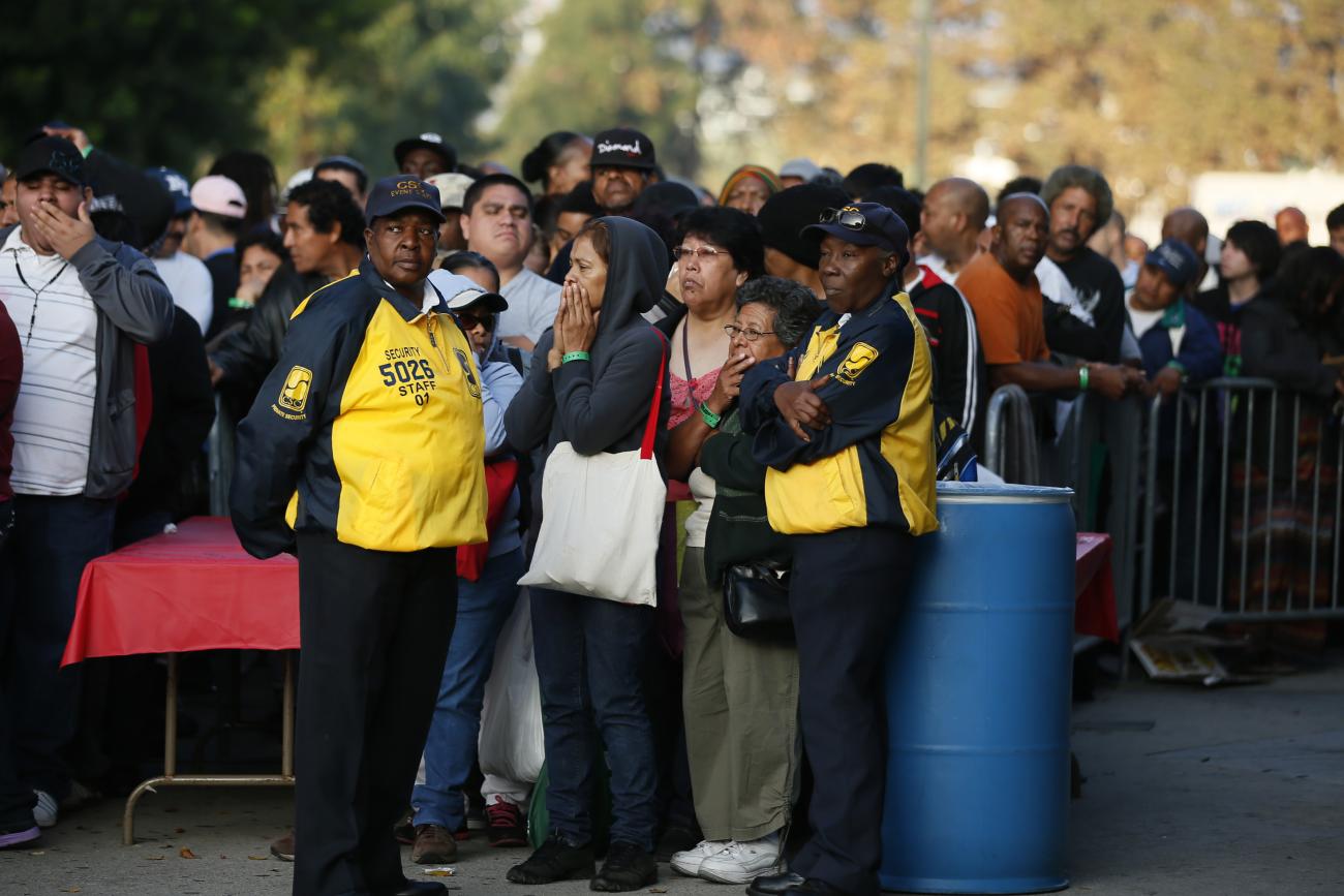 People wait in line at the Care Harbor/LA free clinic in Los Angeles, California, on September 27, 2012. 