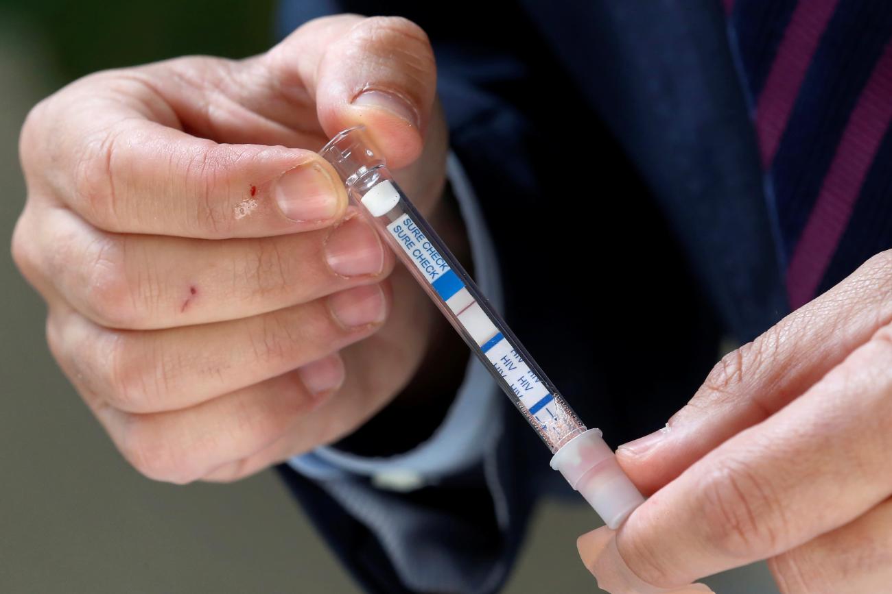 Chilean Senator Francisco Chahuan presents an HIV self-test kit, in effort to encourage people to check their health, in Valparaiso, Chile, on December 11, 2018.