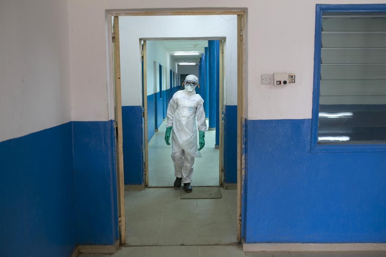 A health worker in protective gear walks inside a Red Cross facility in the town of Koidu, in Sierra Leone, on December 19, 2014.