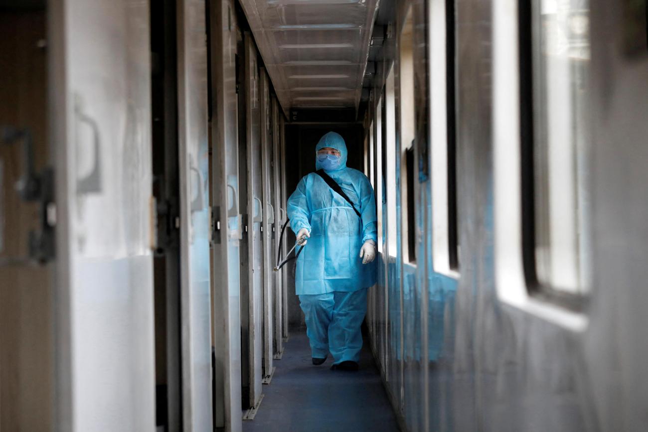 A health worker sprays disinfectants a train as a measure against the COVID-19, in Hanoi, Vietnam, on March 19, 2020.