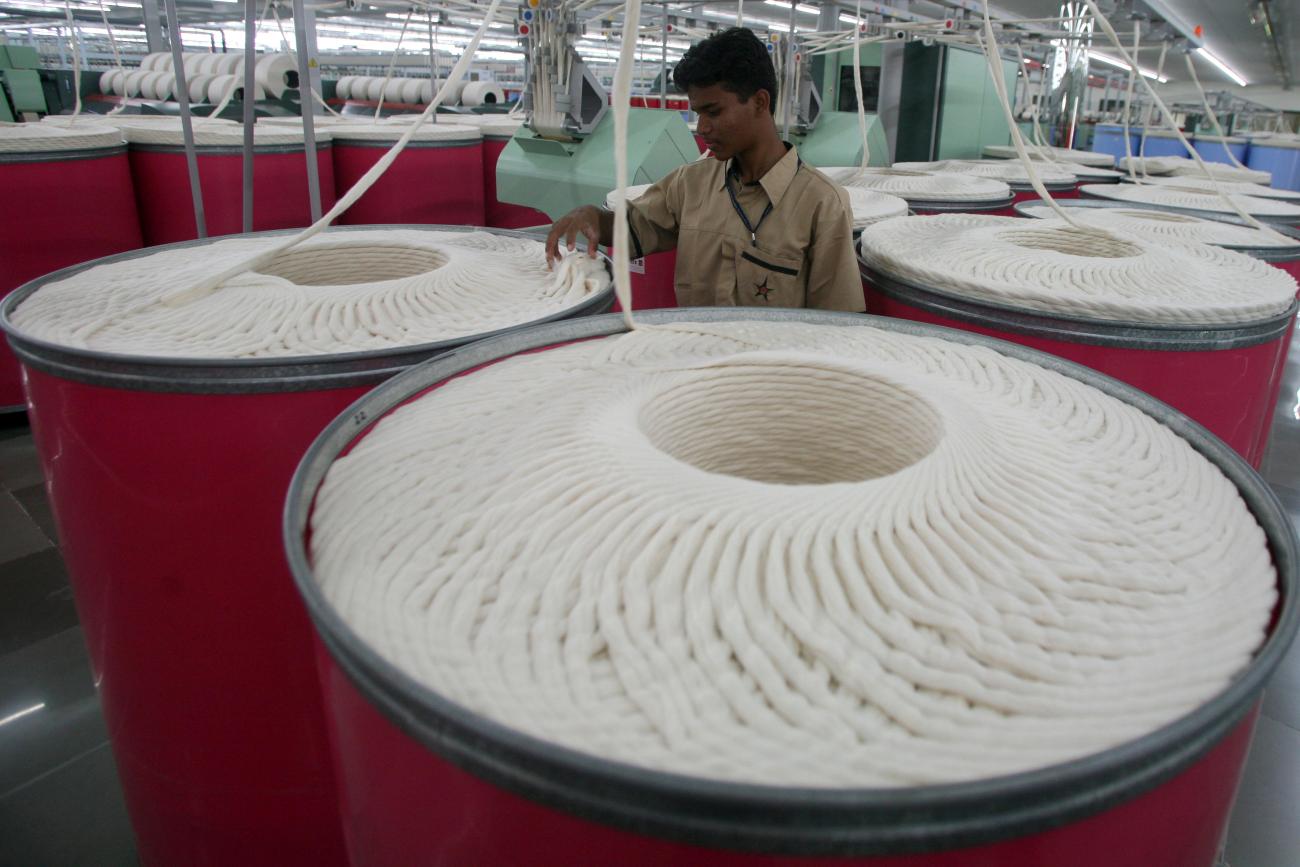 An employee works inside the Century Textiles and Industries Ltd textile mill in Gujarat, India, on October 22, 2009. 