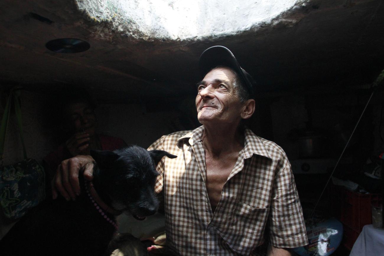 Miguel Restrepo, 62, a former drug addict, looks up from his sewer home in Medellin, Colombia, on December 4, 2012.