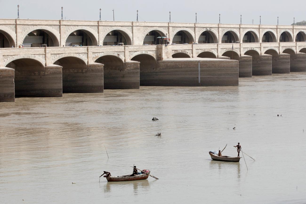 Fishermen row their boats as they catch fish on the Indus River, in Sukkur, Pakistan, on March 19, 2017. 
