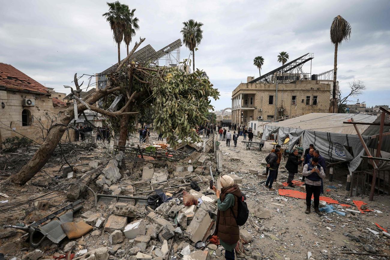 Palestinians inspect the damage after two Israeli missiles hit a building inside the Al-Ahli Arab Baptist Hospital, in the Gaza Strip, on April 13, 2025. 