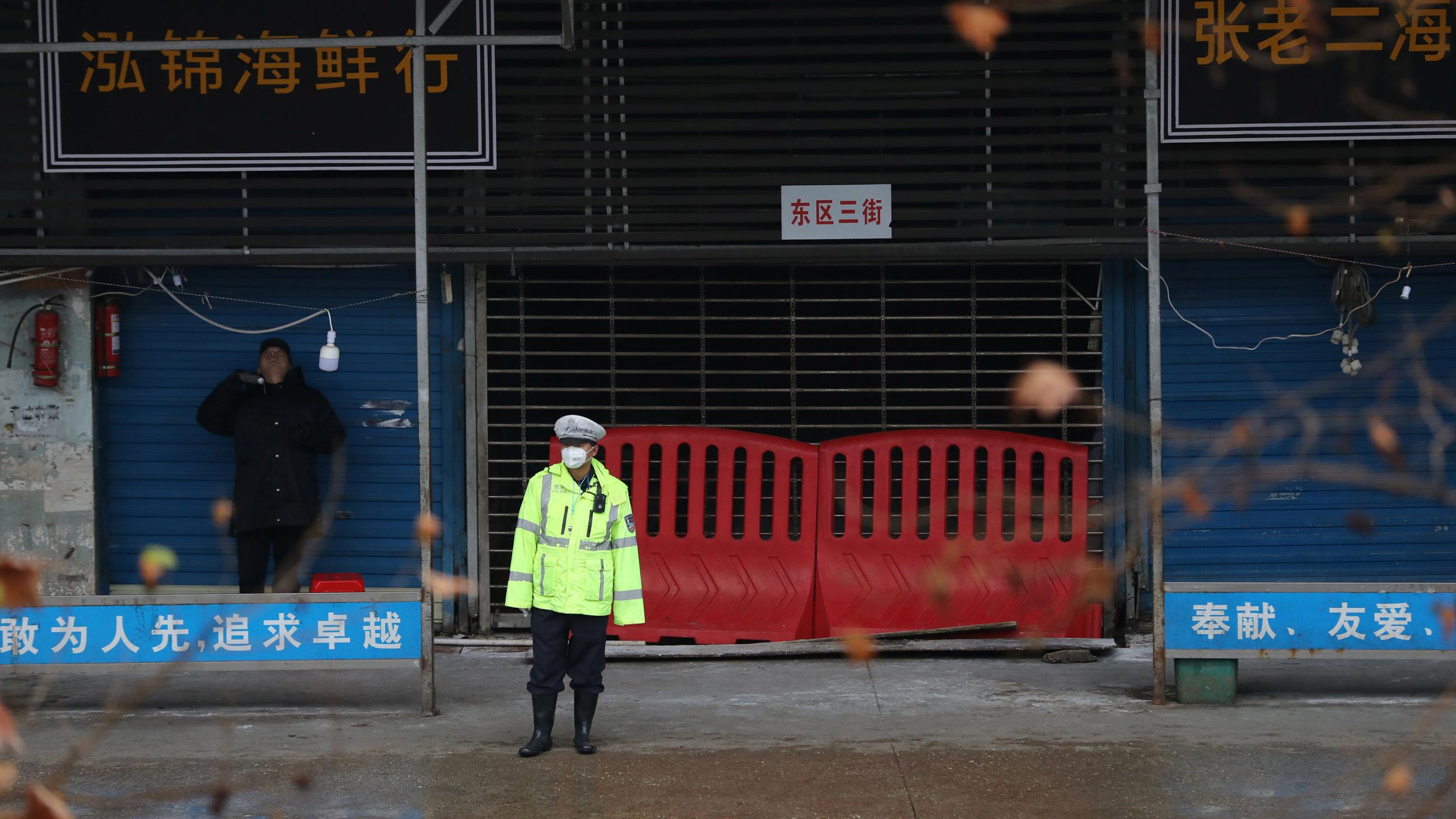 The photo shows a business district street with an officer in front of a shuttered marketplace. Picture taken January 10, 2020.