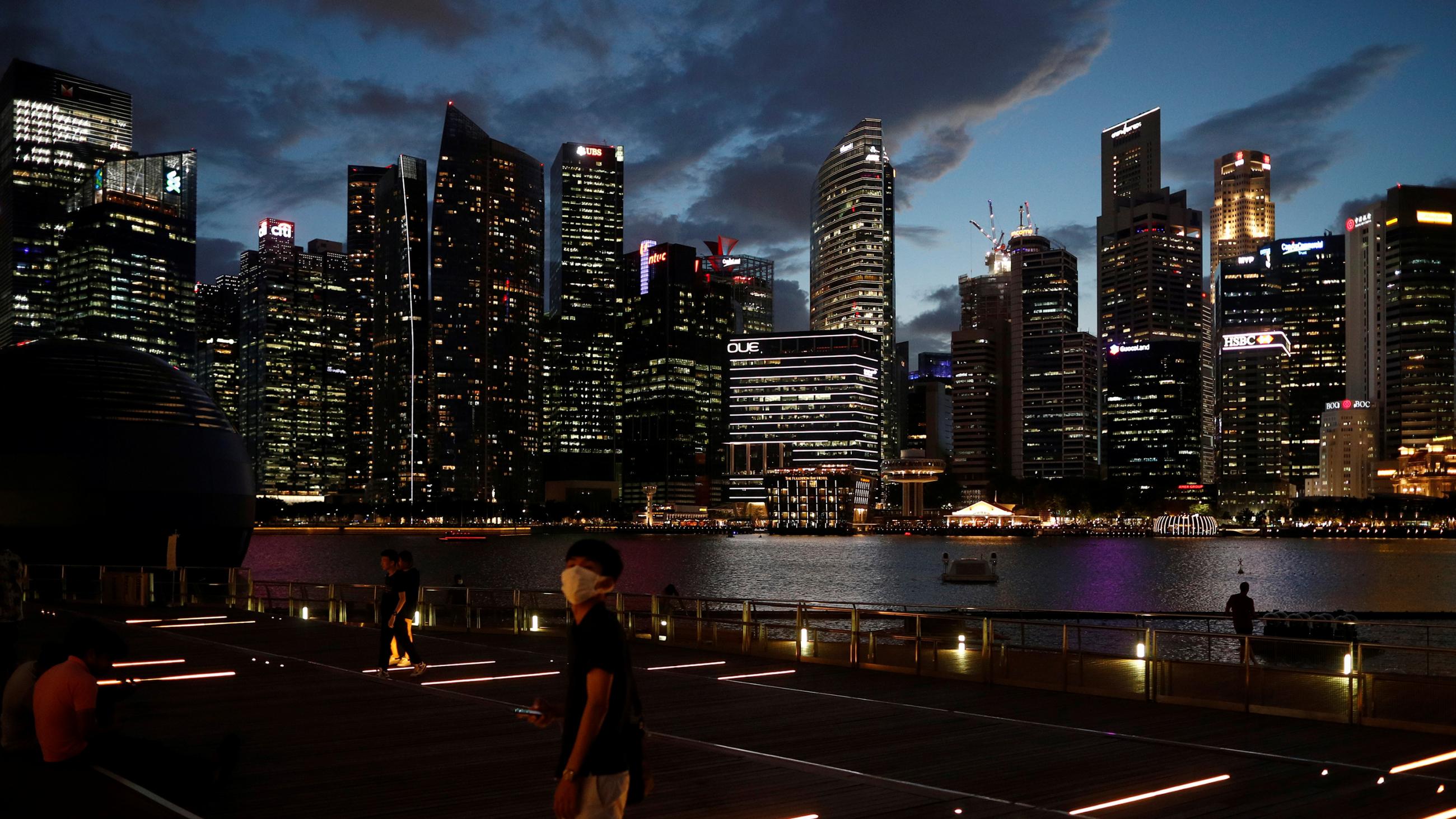 This is a stunning photo showing the Singapore skyline at dusk from across the water. 