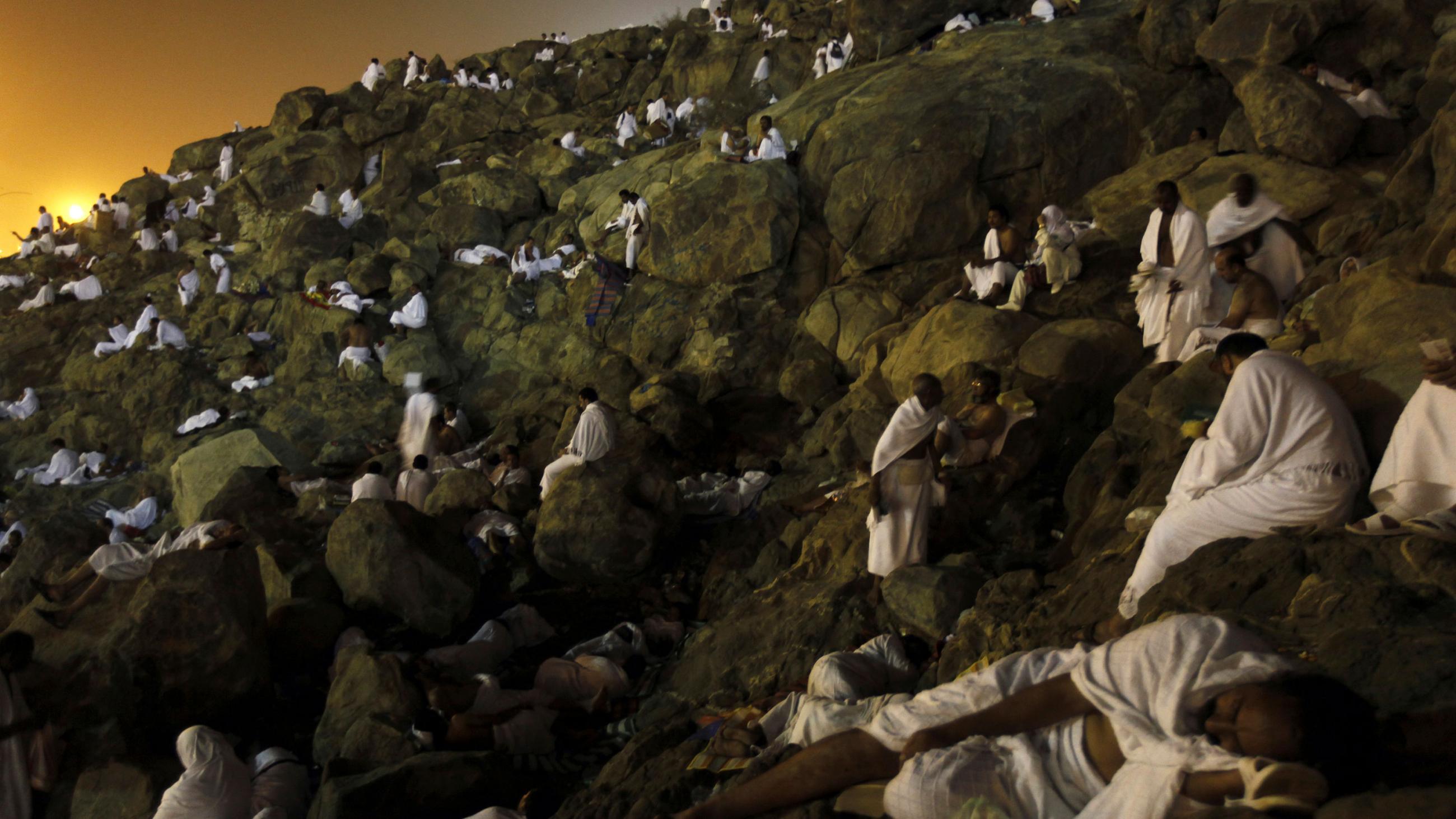 The photo is stunning. Dawn is breaking over the mountain, and hundreds of pilgrims wearing simple white robes are resting on the rocks in twos and threes. 