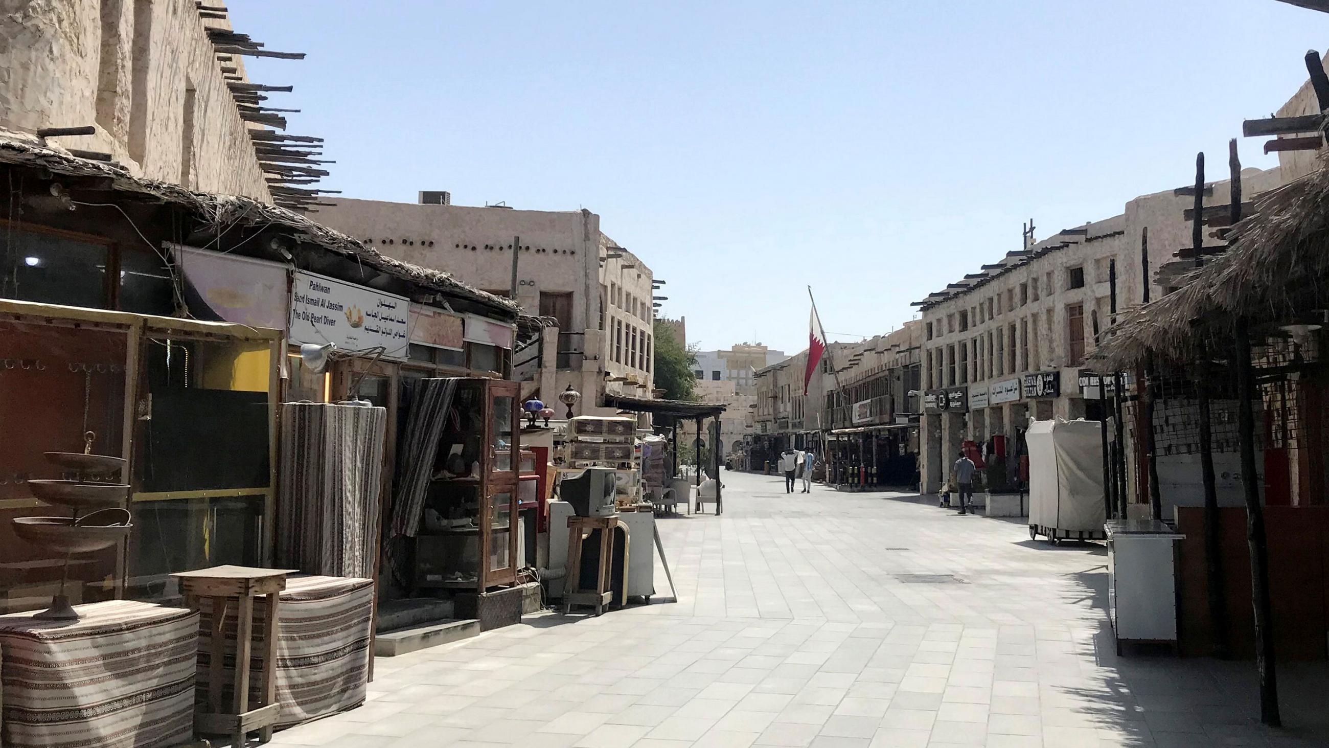 The image shows the empty, mostly abandoned stalls of a Middle Eastern marketplace 