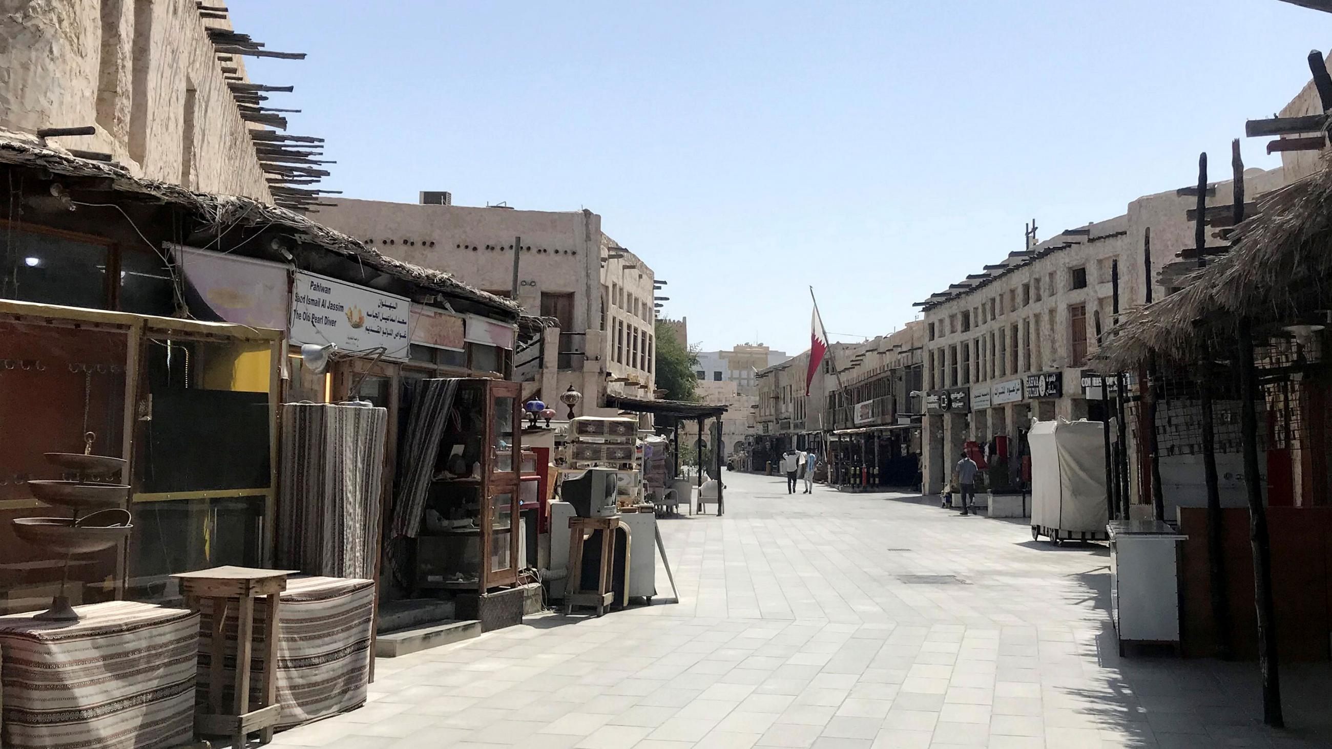The image shows the empty, mostly abandoned stalls of a Middle Eastern marketplace