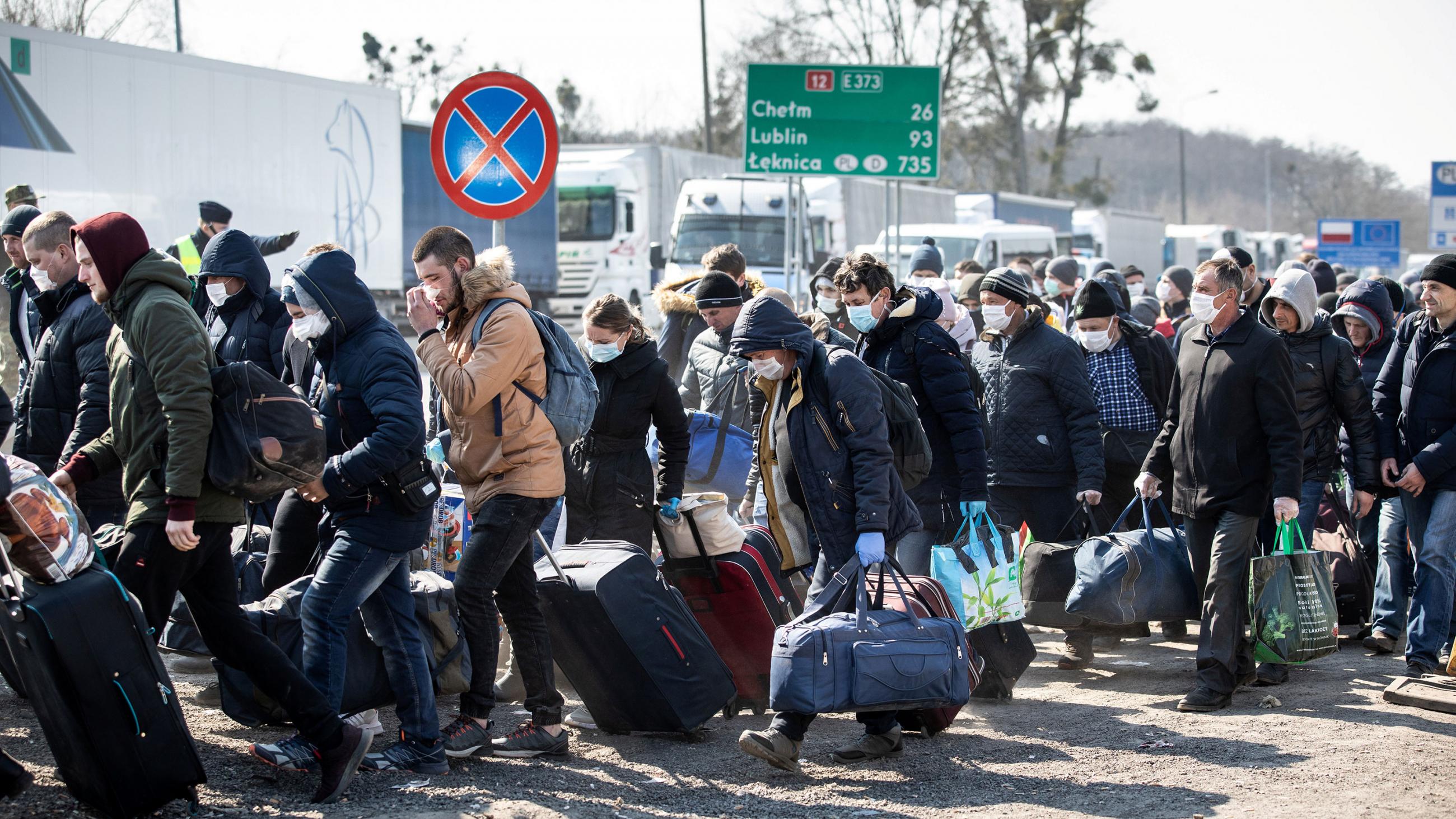 The photo shows a large crowd of people packed together in a line. 