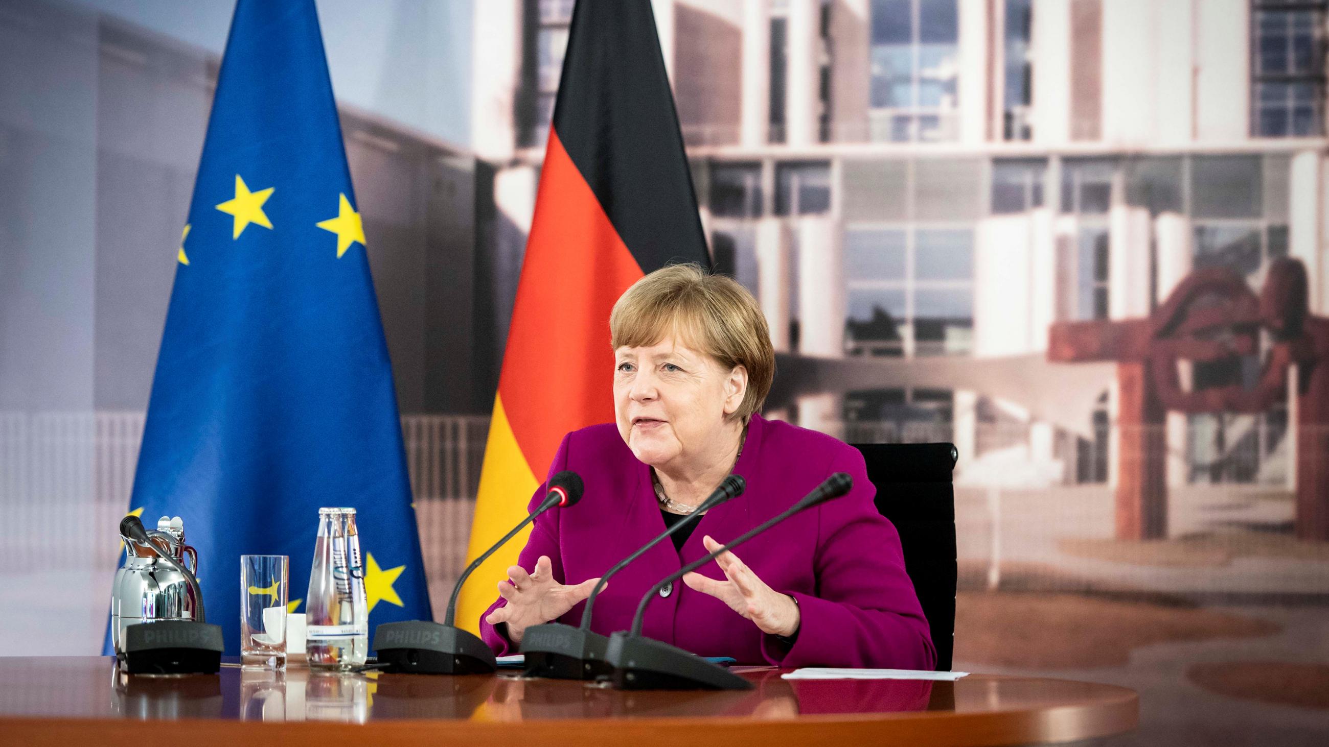 The photo shows the politician at a table speaking into a camera. 