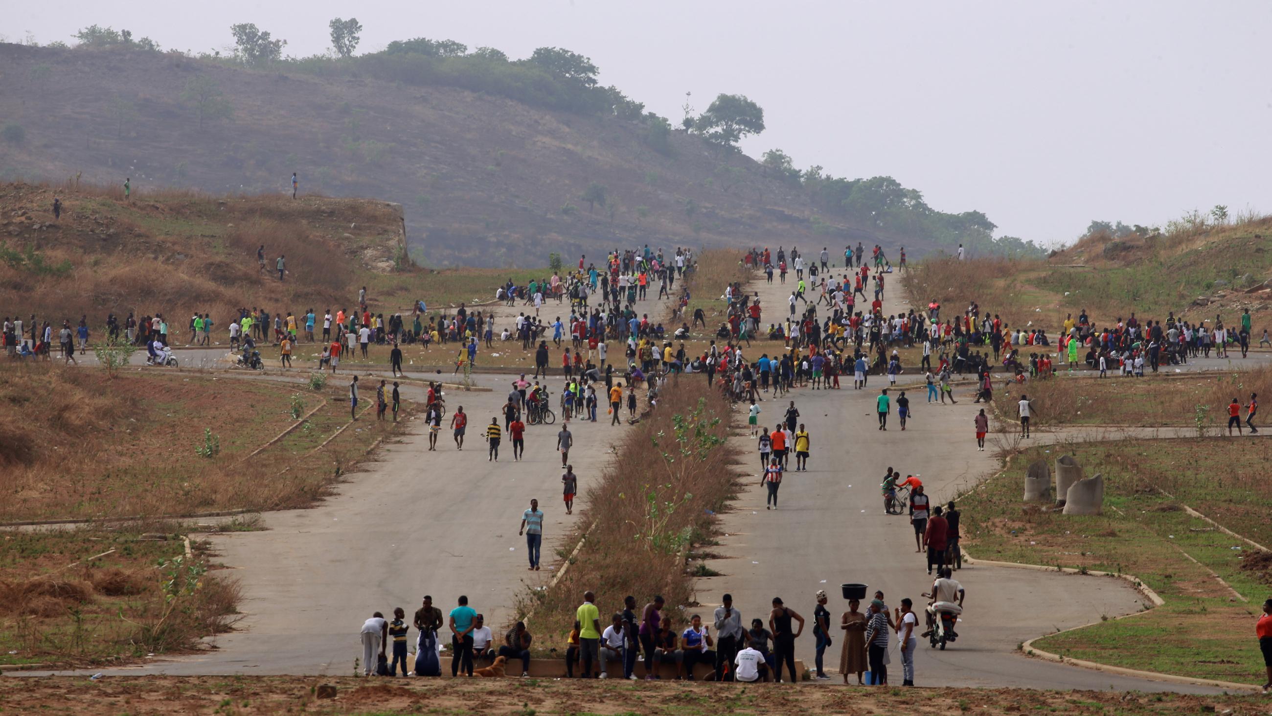 This photo shows a large crossroads from a distance that is filled with people. 