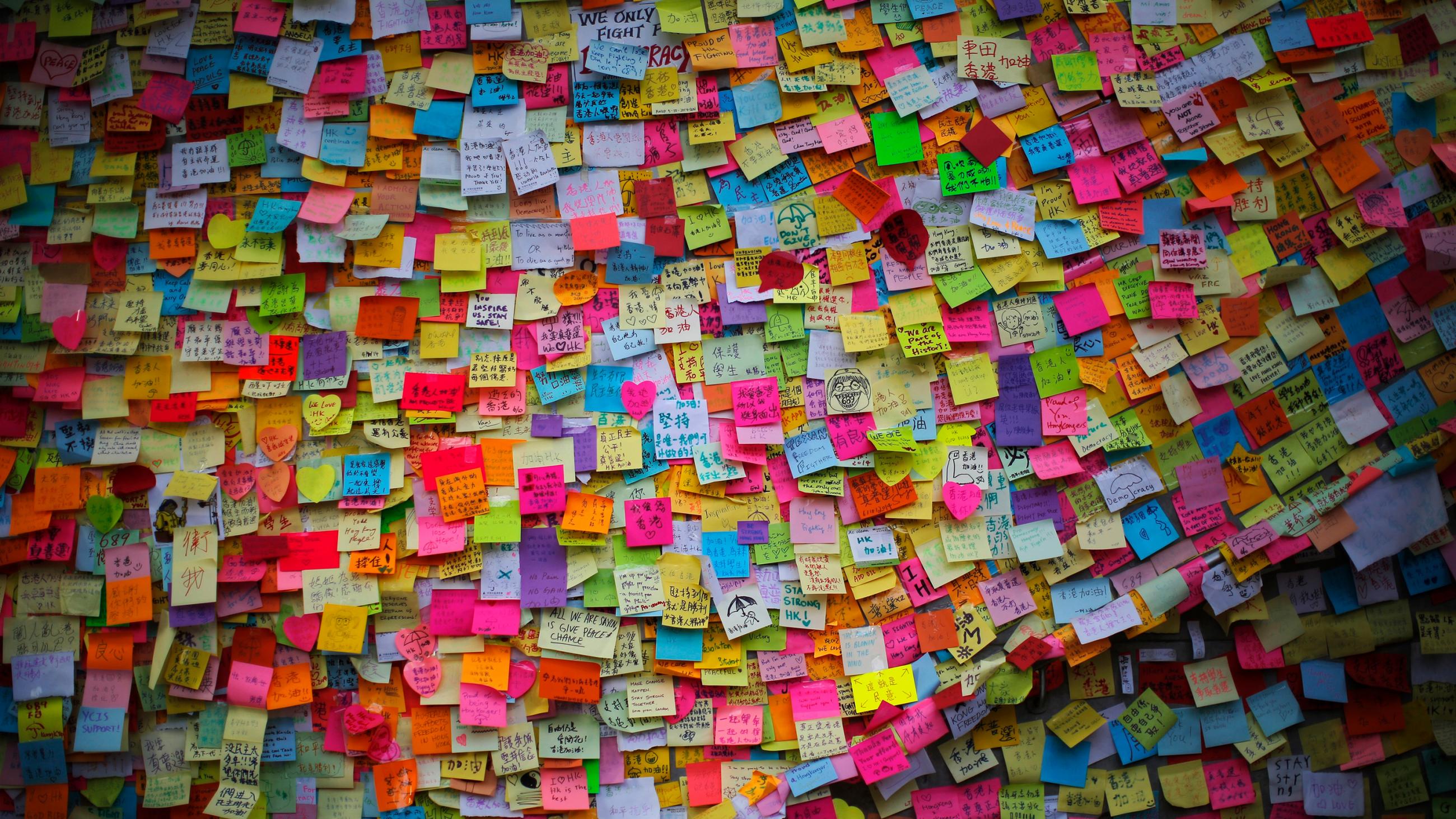Picture shows a wall covered with thousands of stickies.