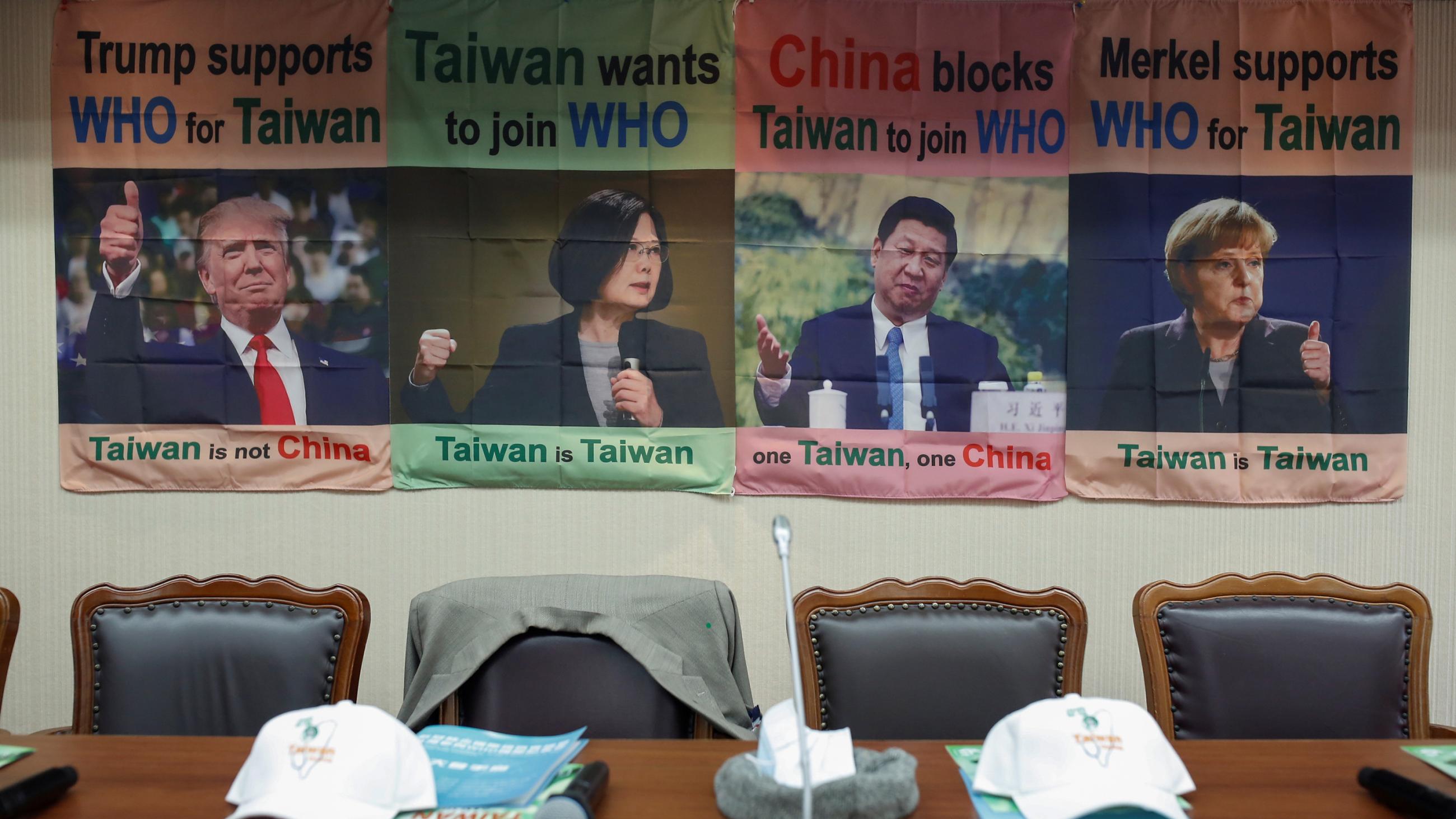 The photo shows empty seats, one with a jacket thrown over the back of it, with posters in the background showing testimonials by world leaders in support of Taiwan's WHO bid. 
