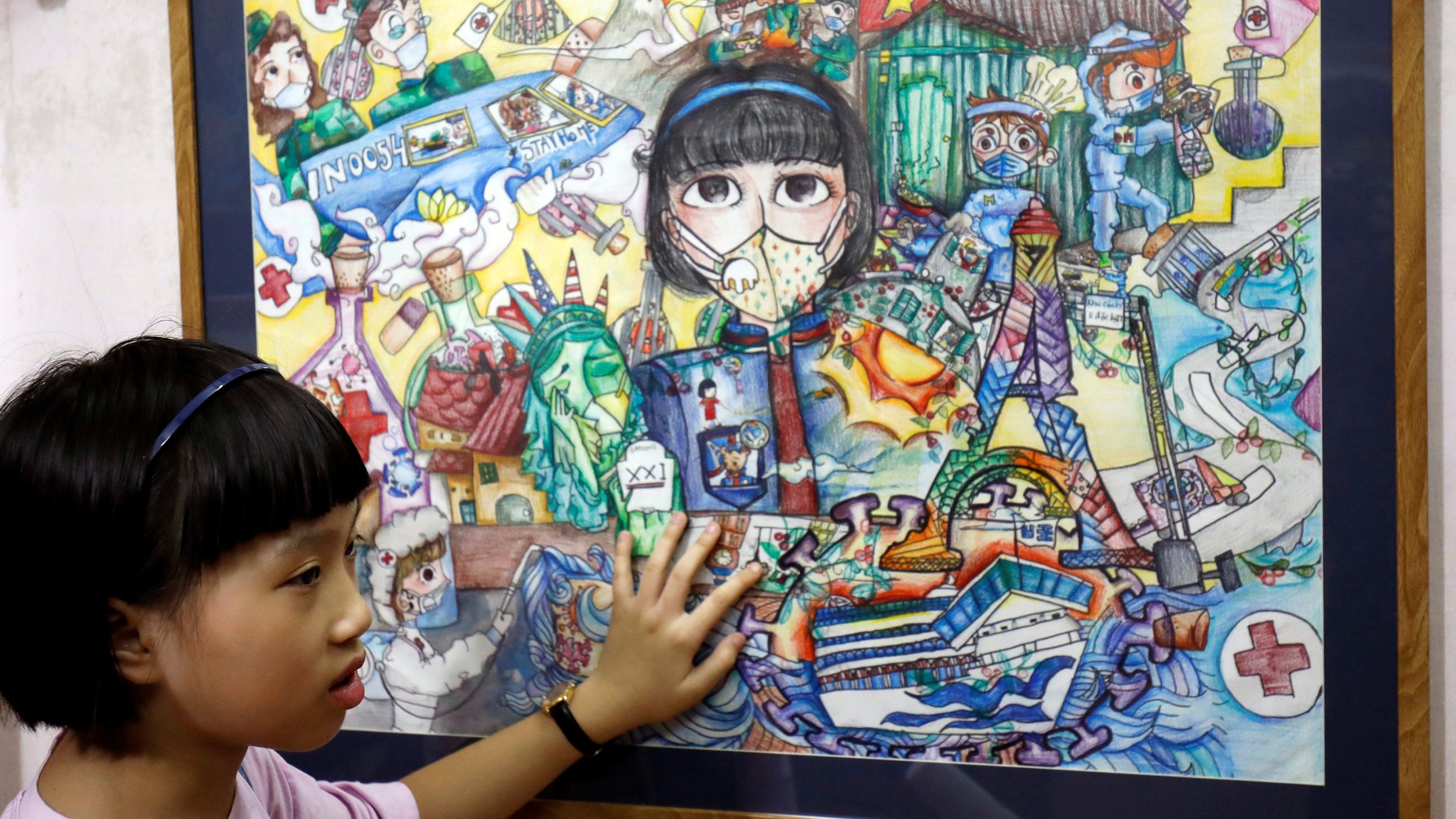 Picture shows the girl standing next to her masterpiece. 