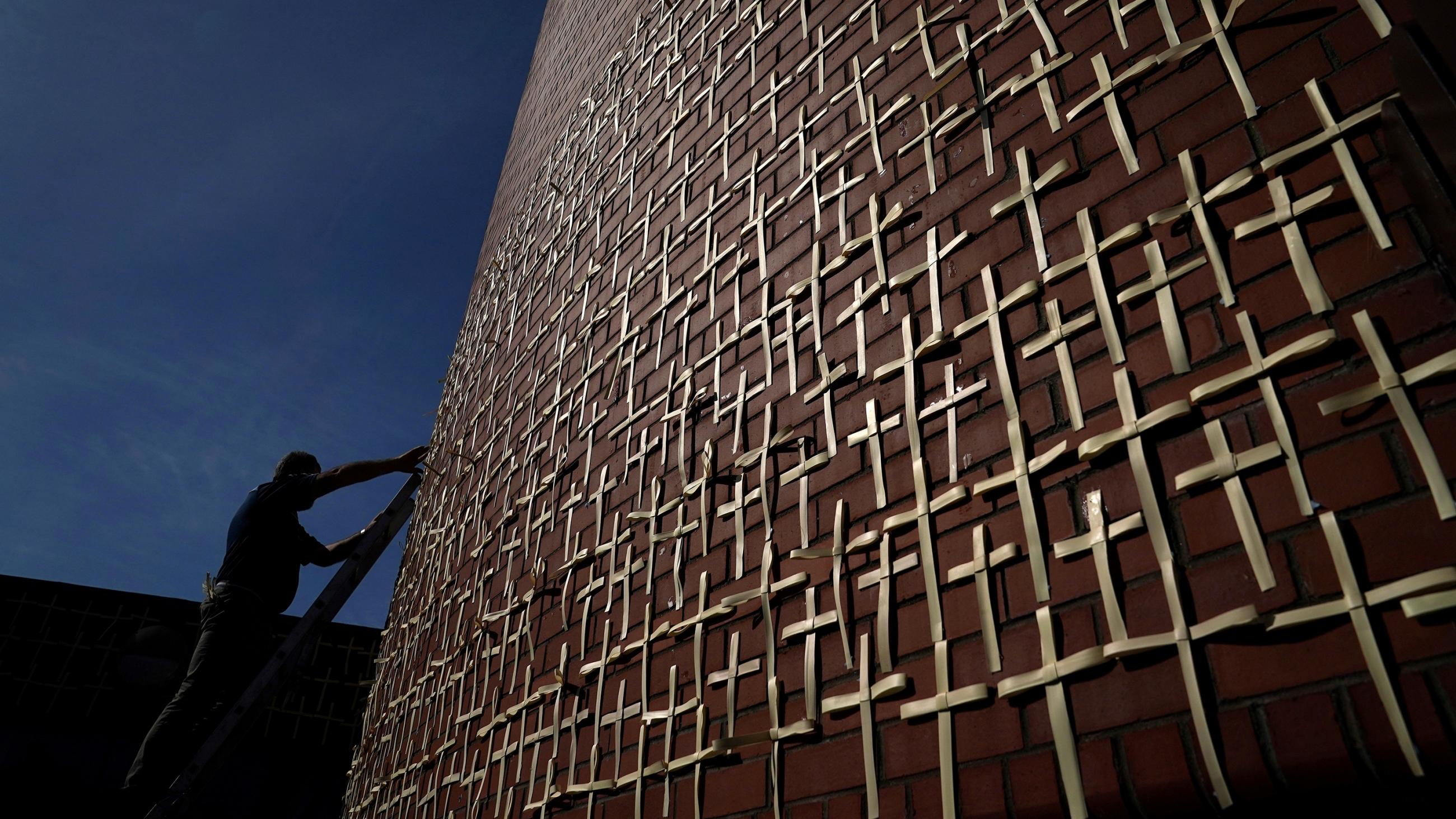 The photo shows the outdoor chapel's wall of crosses, which has become a shrine with each cross representinh a person in Ireland that has died from coronavirus and is added to daily. 