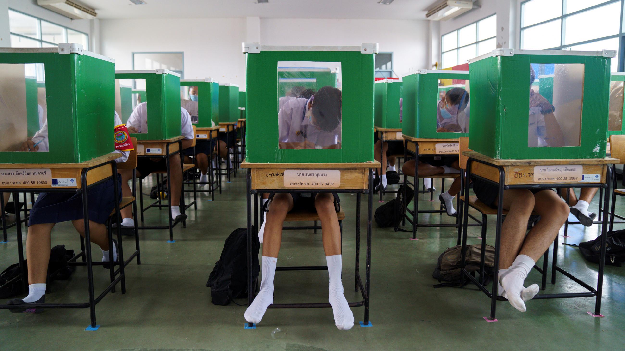 The photo shows a classroom where all the students are inside their own ballot boxes. 