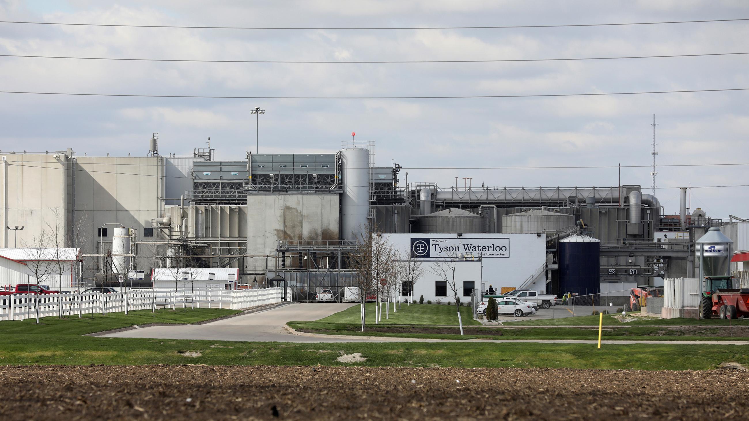 The photo shows the shuttered plant from behind a fence at a distance. 