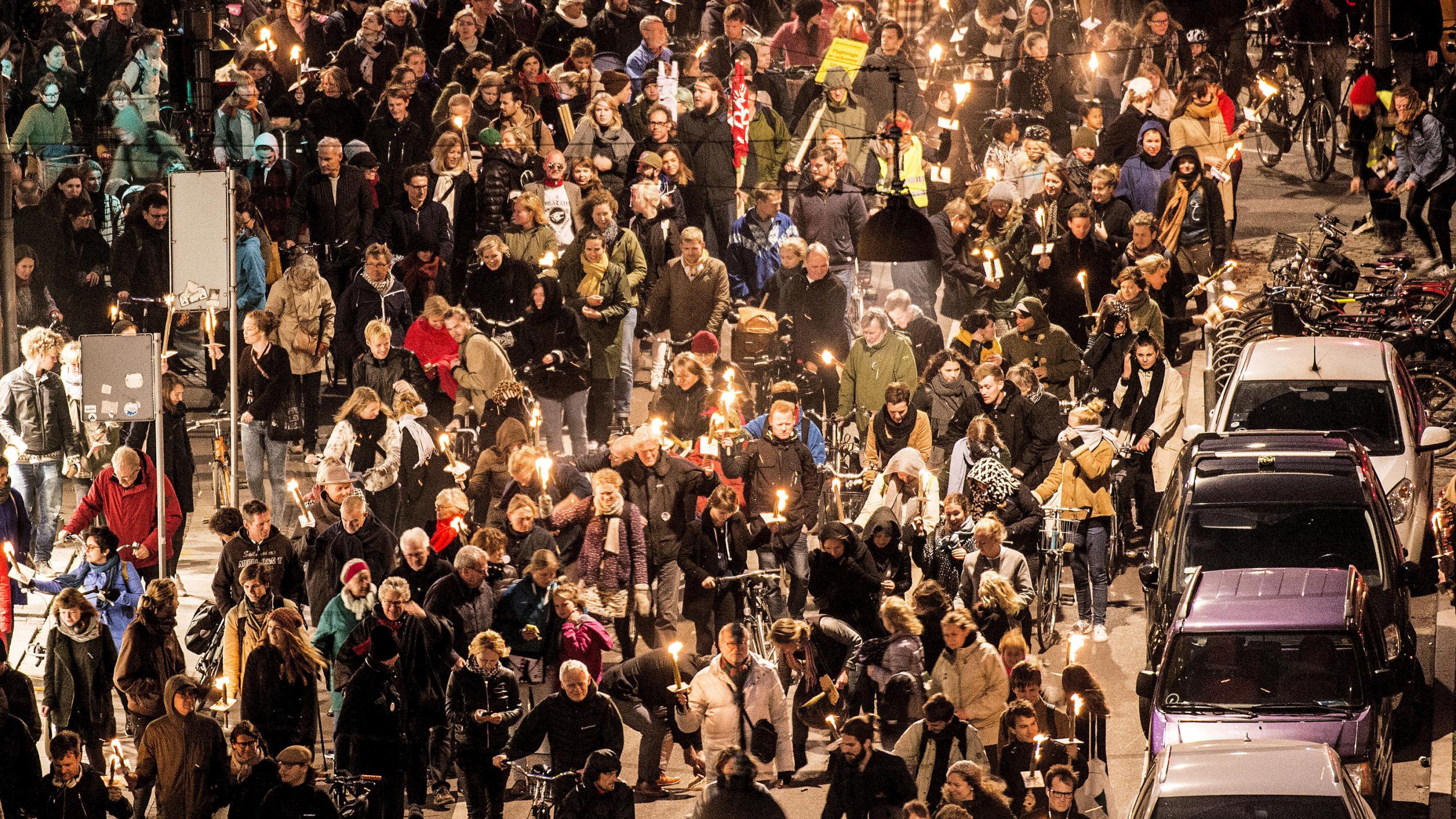 The photo shows a massive crowd of people marching through the streets. 