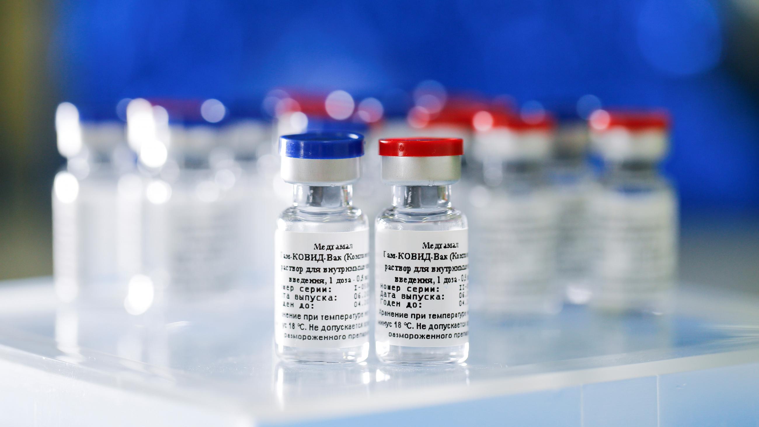 Picture shows two vials, one with a red cap and one with a blue. 