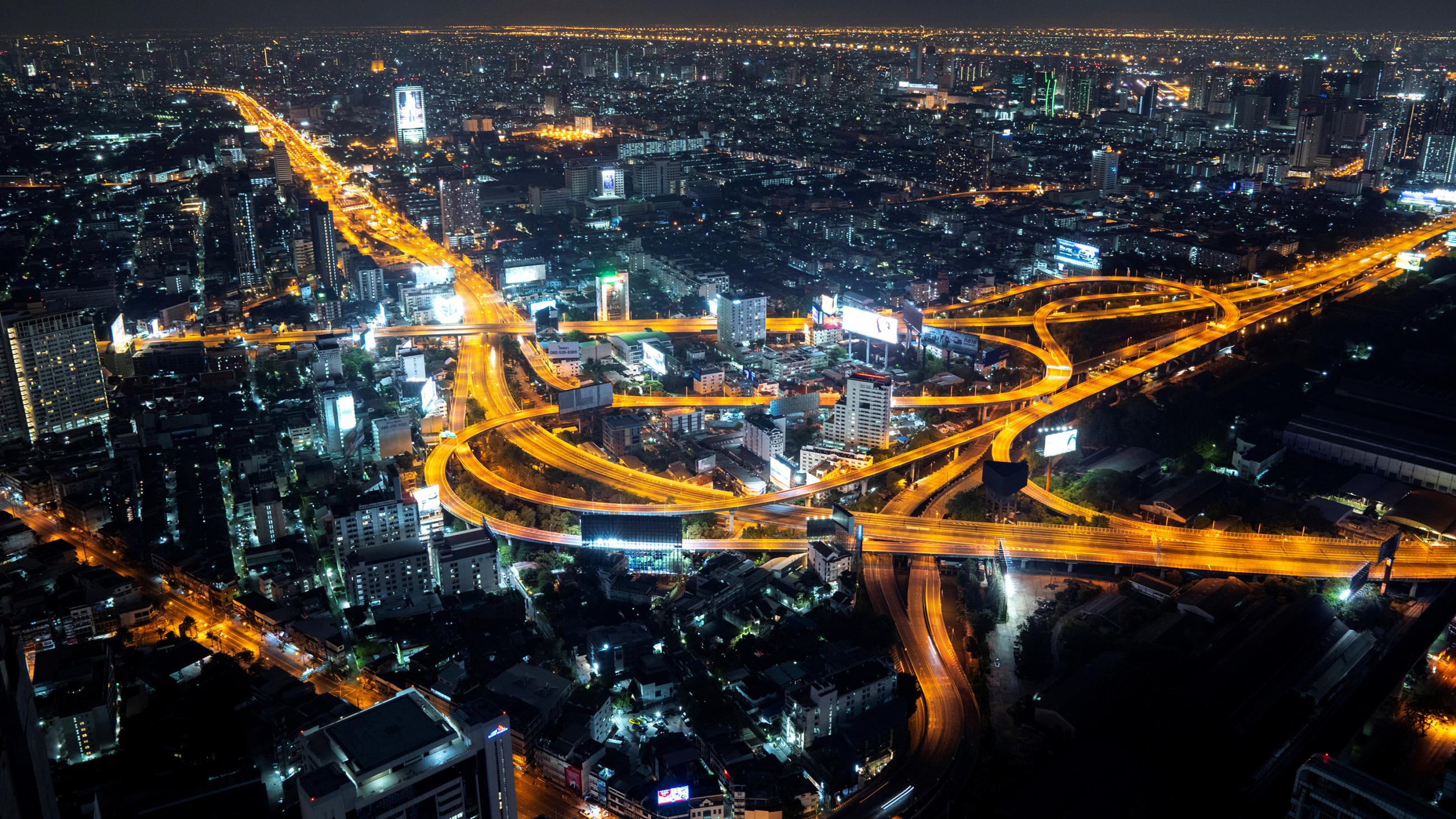 The photo shows a view of the city from a high tower at night.