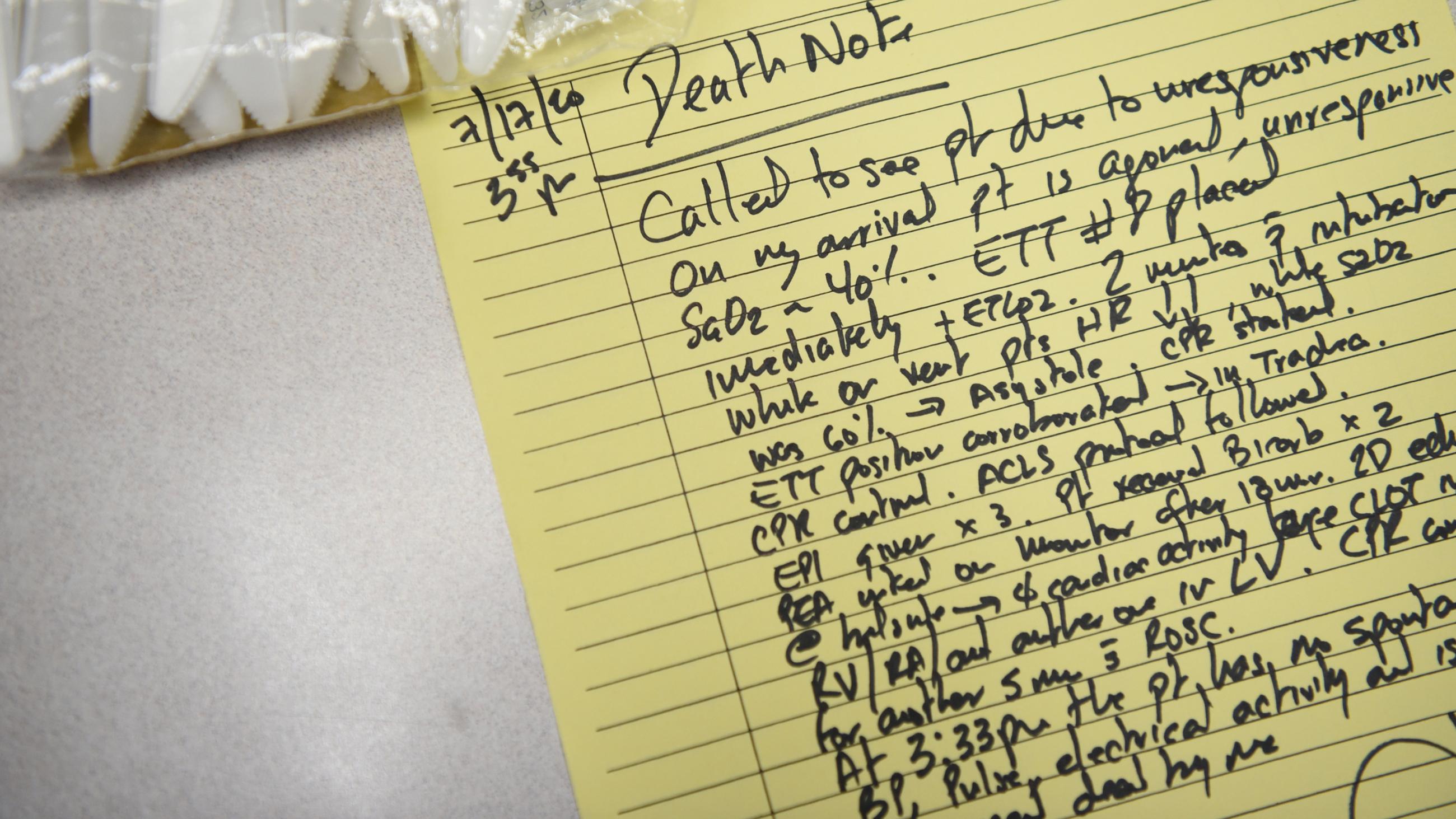 The photo shows a hand-written note with lots of detailed medical observations on a yellow pad. 