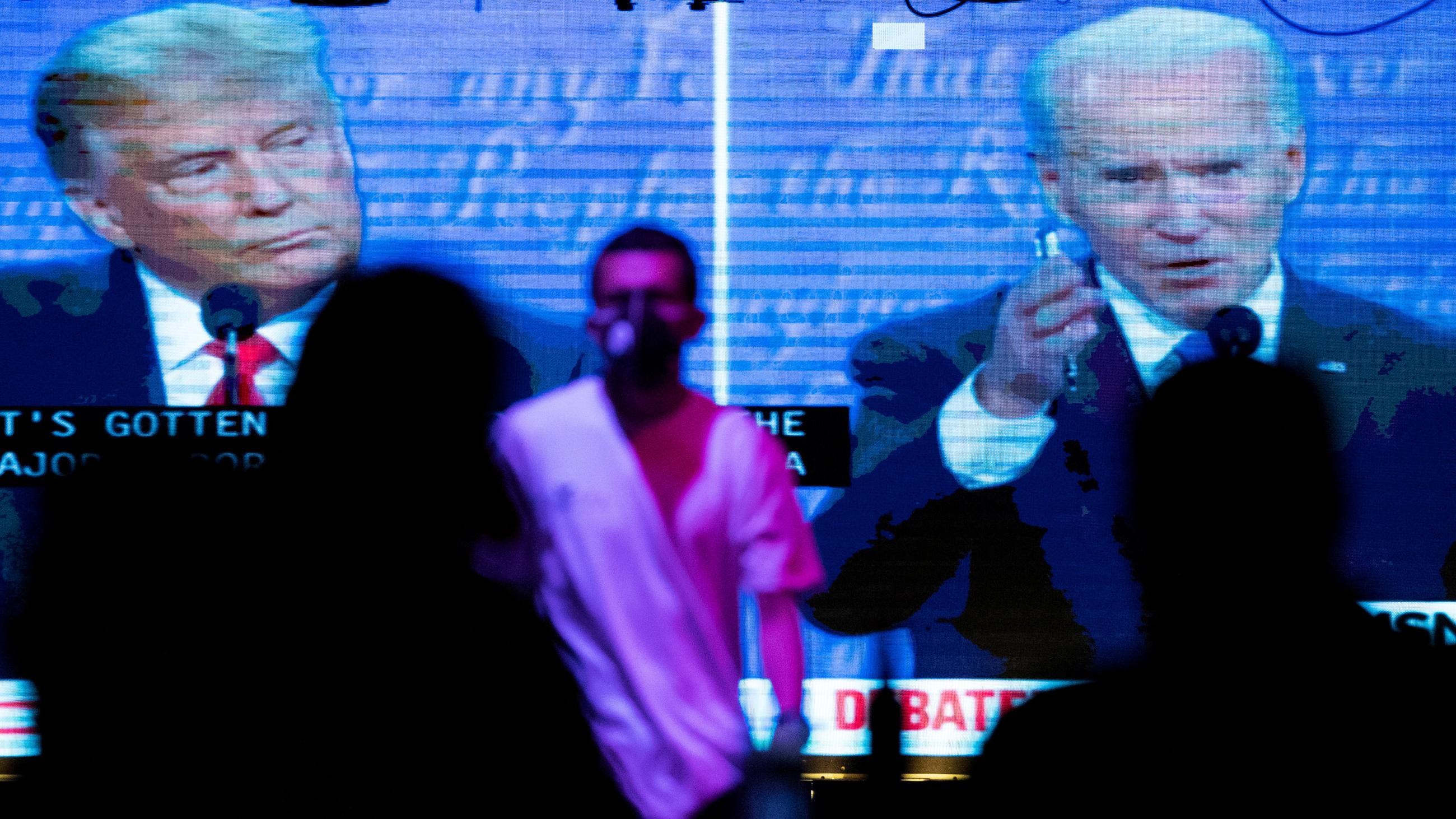 People watch the second presidential debate between Democratic presidential nominee Joe Biden and U.S. President Donald Trump during the COVID-19 outbreak in West Hollywood, California, on October 22, 2020.