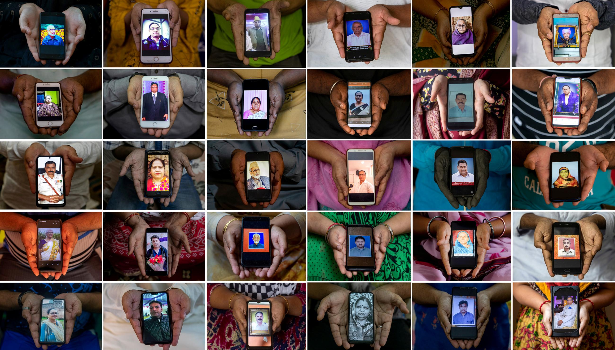 The picture shows people holding their mobile phones, showing images of their relatives who died. 