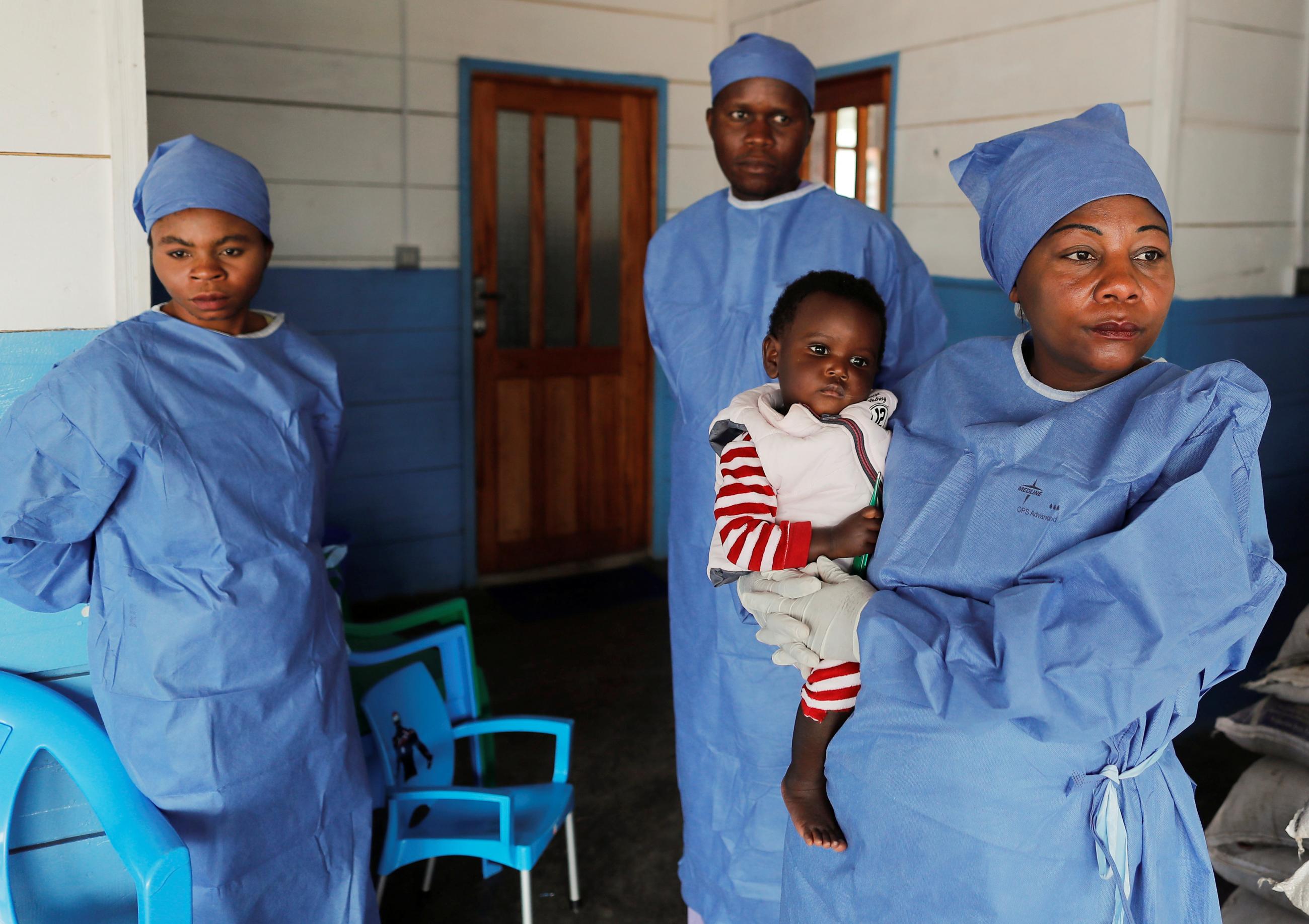 Arlette Kavugho, 40, mother of six and Ebola survivor who works as a caregiver, carries Kambale Eloge, 16 months old, whose mother died of Ebola, during her visit to the United Nations Children's Fund (UNICEF) creche for children whose families are suspected or confirmed Ebola cases, in Katwa, near Butembo, in the Democratic Republic of Congo, October 2, 2019. Kavugho was discharged from an Ebola ward in March 2019. When she tried to return to work as a seamstress in her hometown of Butembo, her customers w