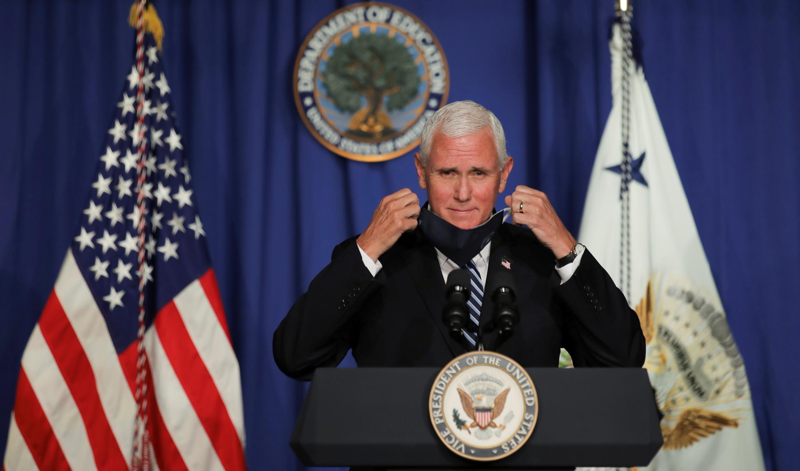 U.S. Vice President Mike Pence takes off his protective face mask to speak as he leads a White House coronavirus disease (COVID-19) task force briefing at the U.S. Education Department in Washington, U.S., July 8, 2020.