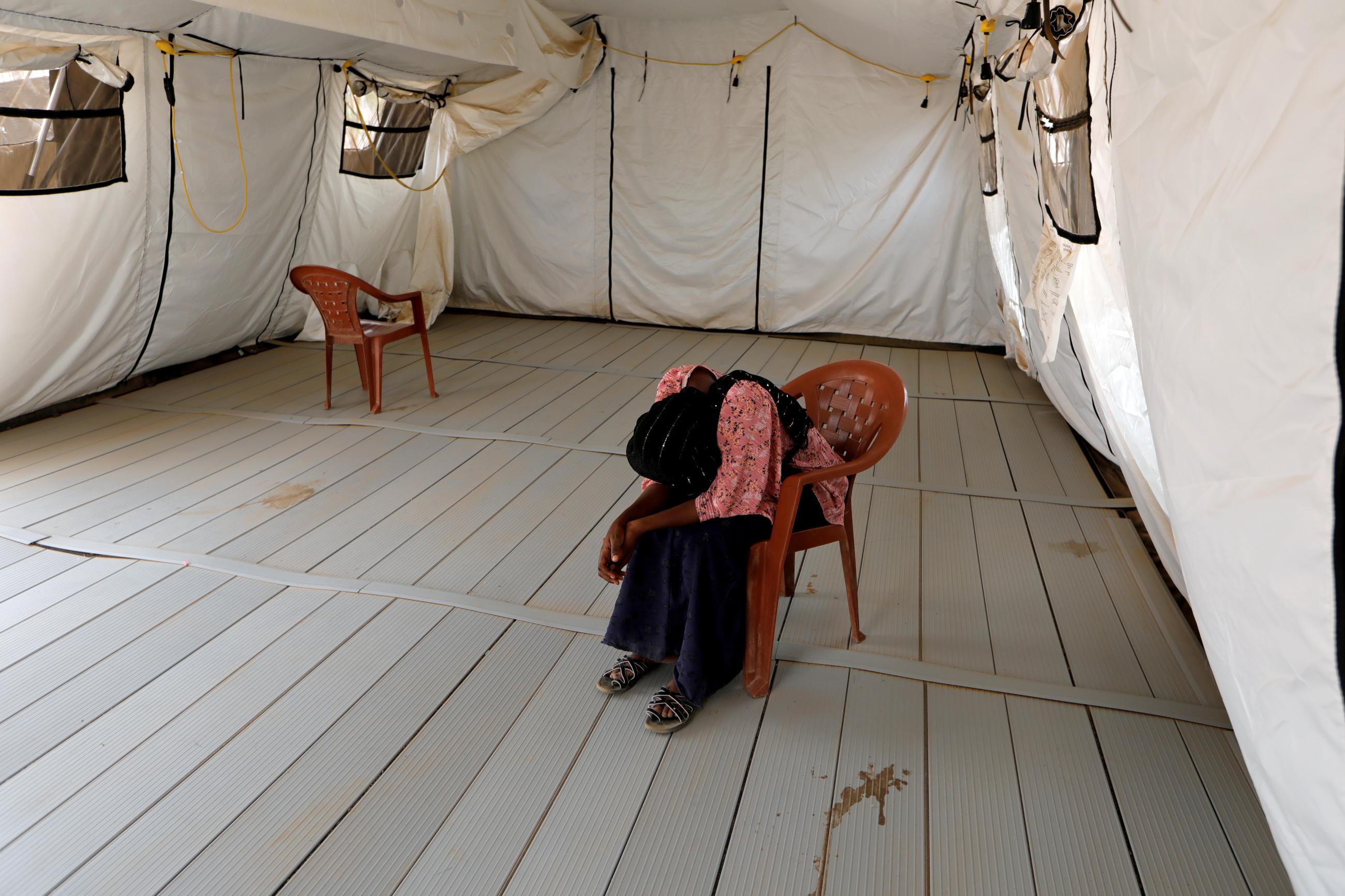 A local resident waits to be examined after she was isolated due to the symptoms of the coronavirus disease (COVID-19), inside an isolation tent for suspected cases at the army field hospital in Touba, Senegal May 1, 2020.
