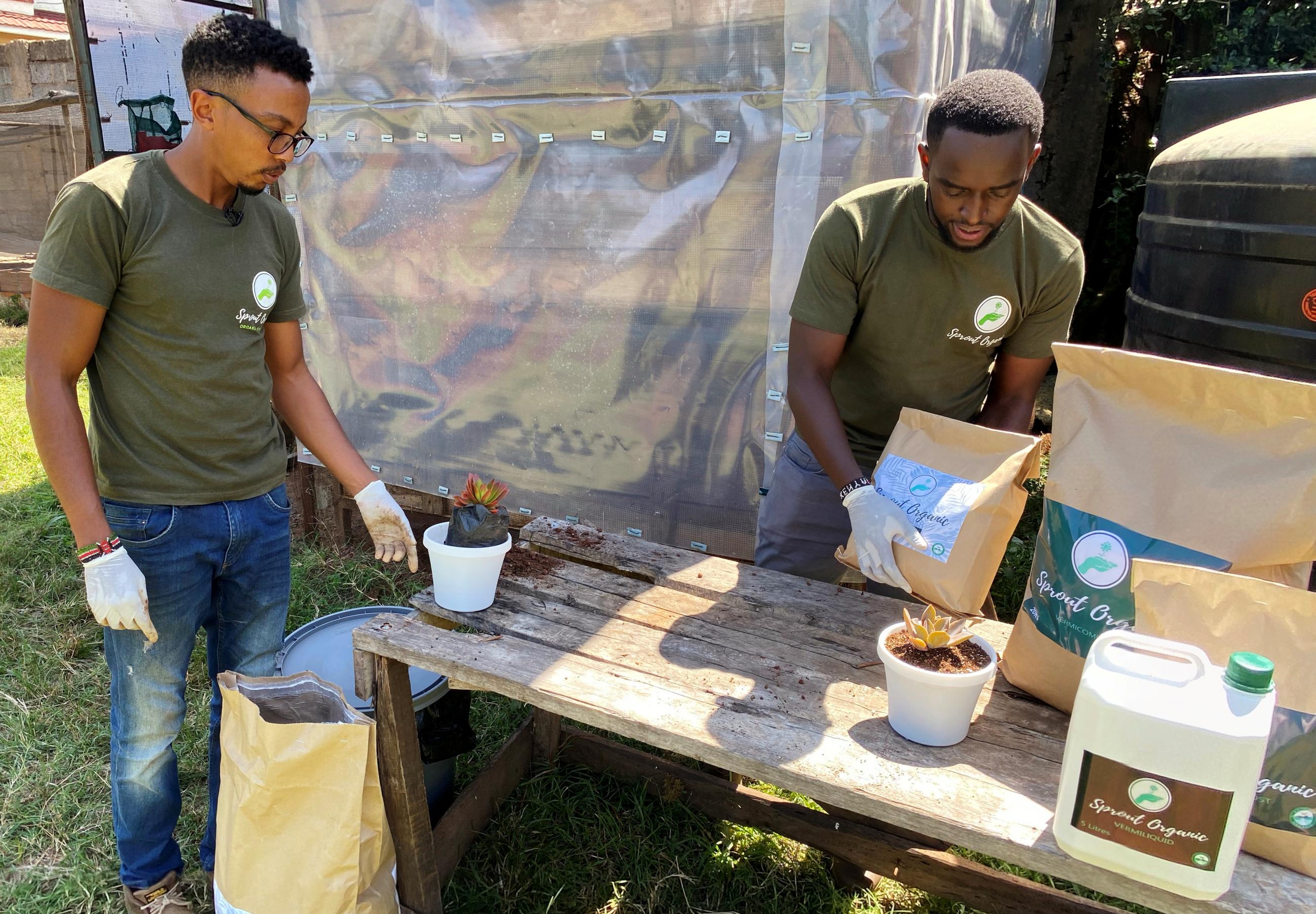 Ted Gachanga and Michael Kanywiria agronomists who co-own Sprout Organic company carry samples of a compost that is sold to urban farmers to grow food in squeezed spaces during the coronavirus disease (COVID-19) outbreak in Nairobi, Kenya June 30, 2020.