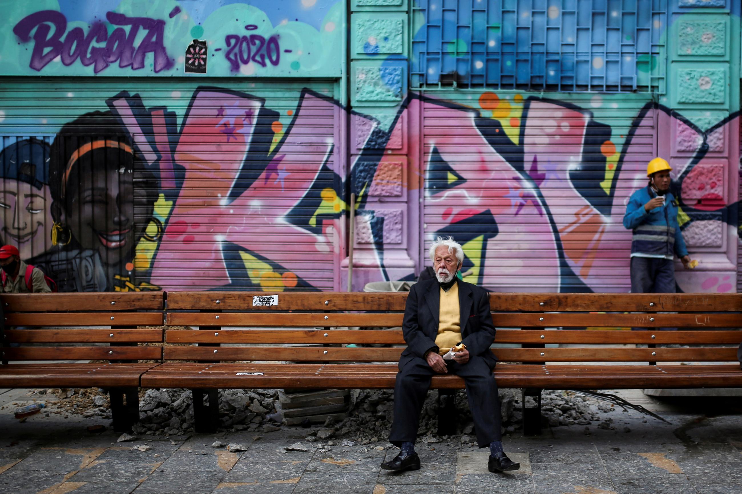A man sits on a street bench during the government-mandated quarantine to lower the rates of contagion from the coronavirus disease (COVID-19) outbreak, in Bogota, Colombia on July 27, 2020.