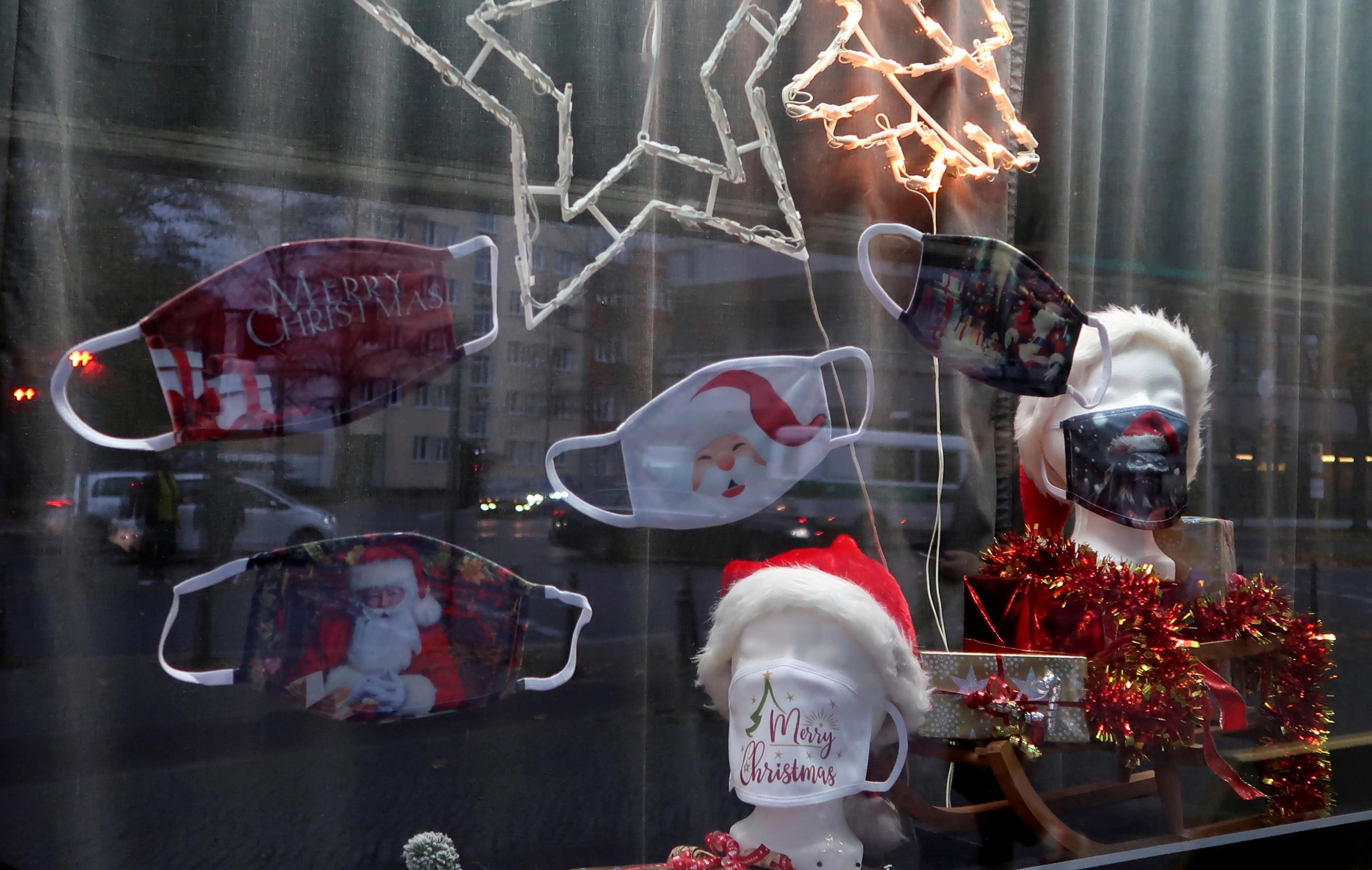 Face masks on sale are pictured as Christmas decoration at a photography studio's window, as the spread of the coronavirus disease (COVID-19) continues, in Berlin, Germany, November 11, 2020.